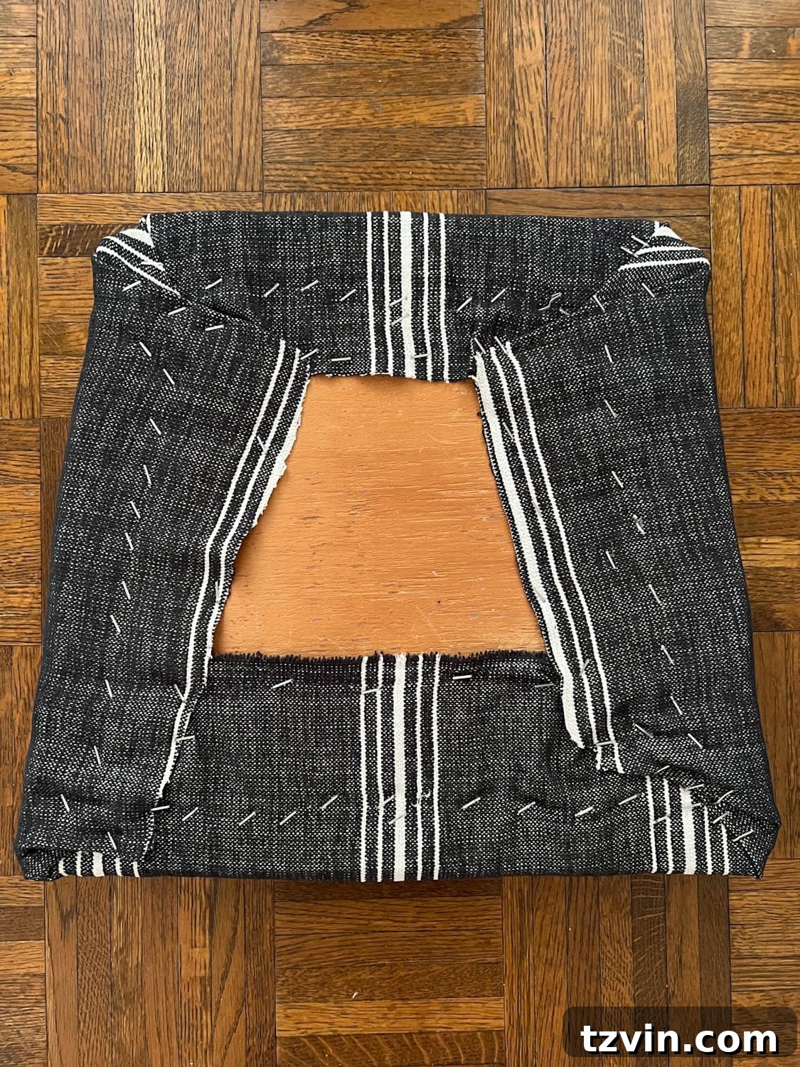 Revitalize Your Dining Chairs Seat Reupholstery and Faux Bamboo Transformation 7 underside of recovering a dining chair seat with upholstery fabric and a staple gun