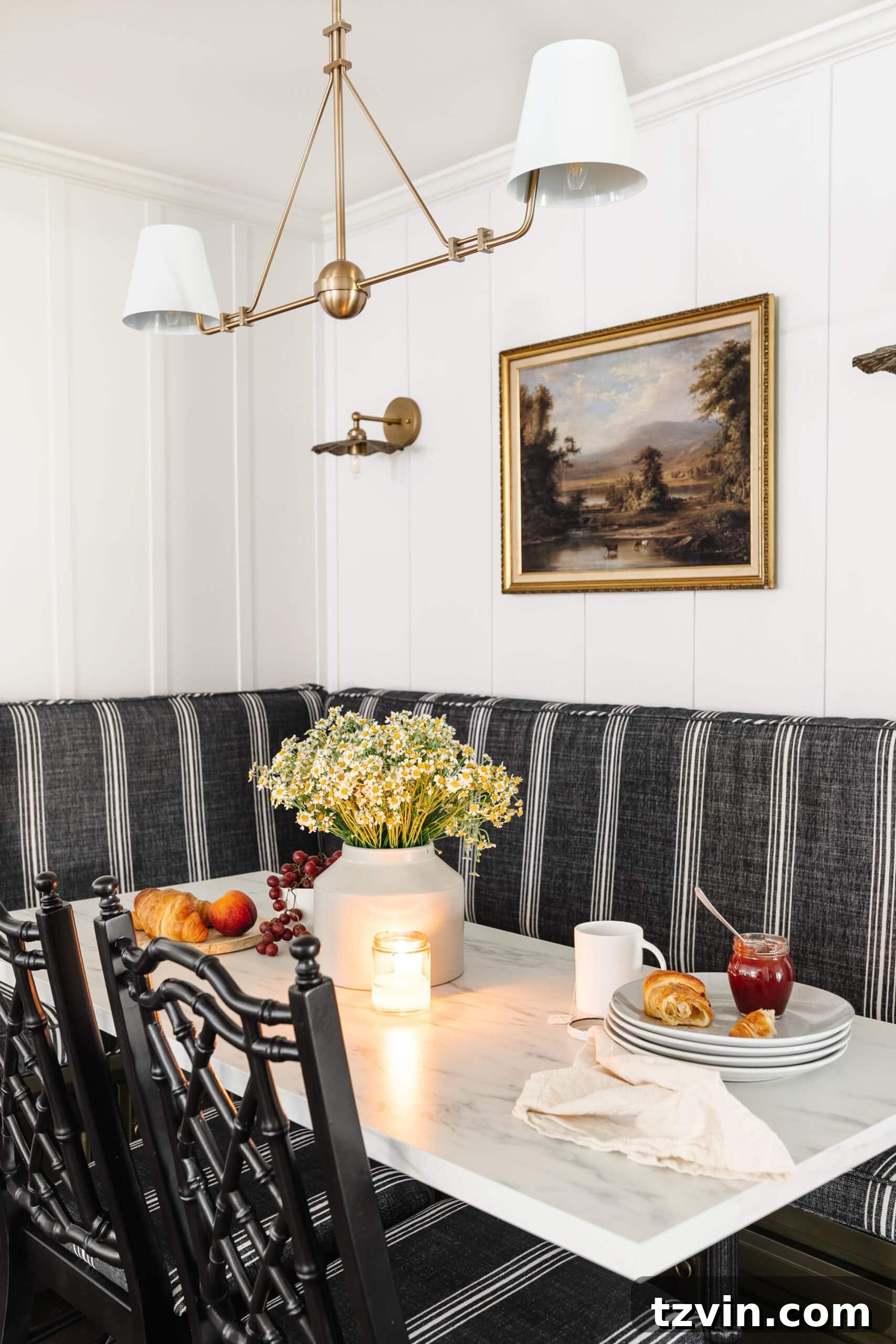 Chic Parisian Morning Retreat 13 Beautiful vase of flowers positioned on a marble dining table in a cozy corner breakfast nook, enhancing the inviting atmosphere