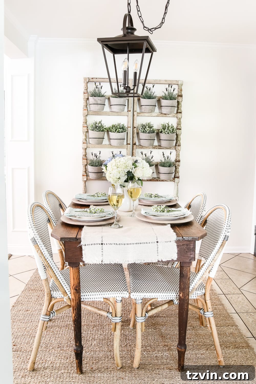 Chic Parisian Morning Retreat 18 Rustic farmhouse style breakfast nook featuring a charming wall planter, a farmhouse wood table, and classic French bistro chairs