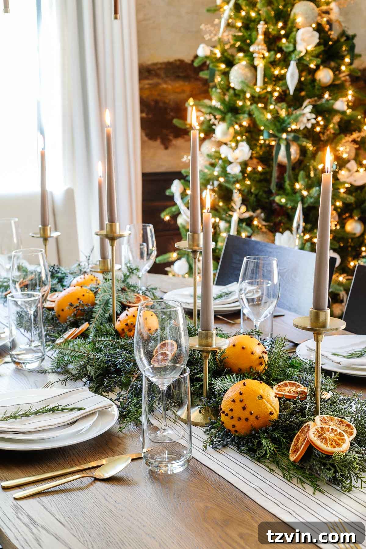 Effortless Table Settings for Every Occasion 12 Christmas dining table centerpiece with leaves and dried oranges slices and candlesticks