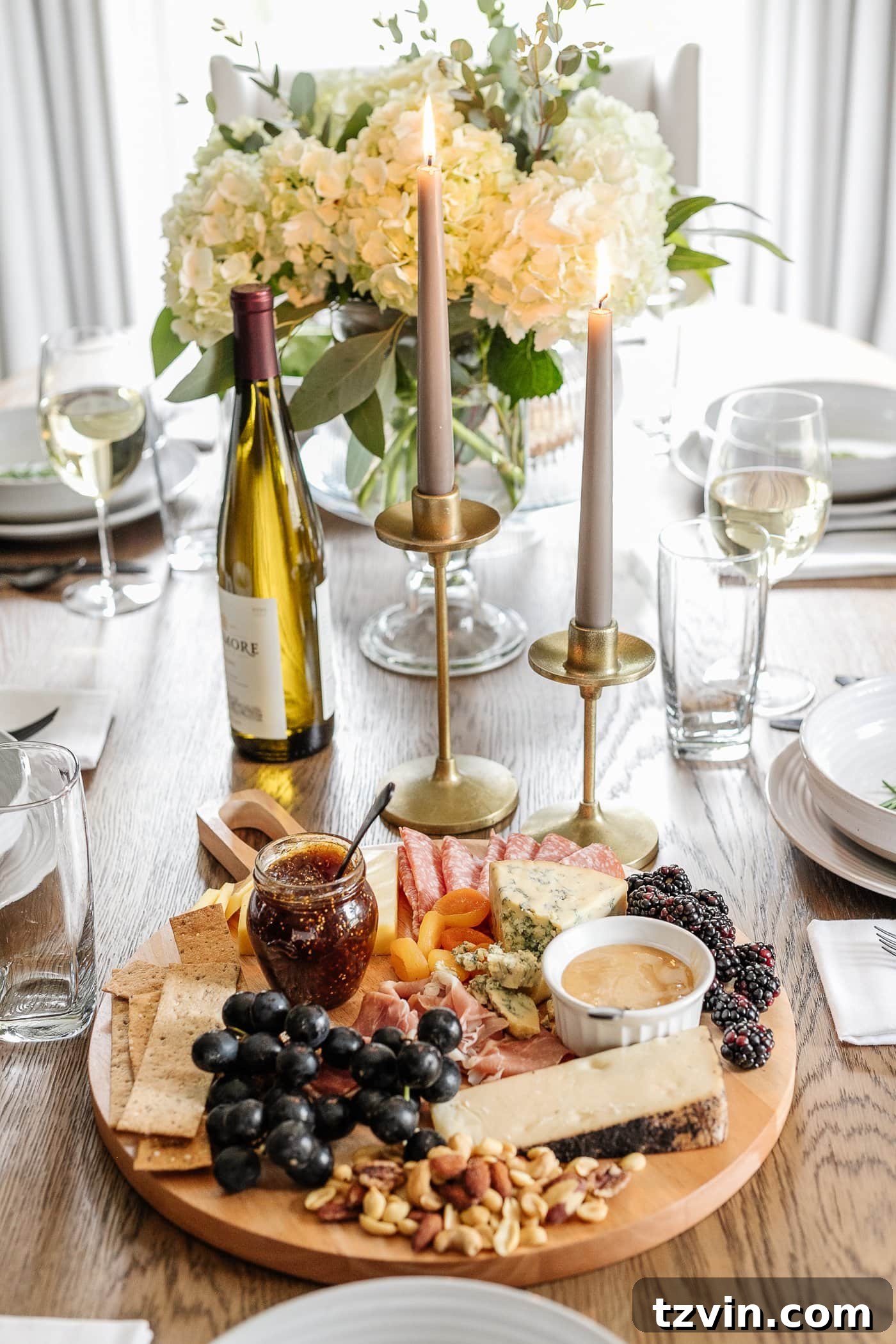 Effortless Table Settings for Every Occasion 13 charcuterie board, candlesticks, and vase of flowers for simple dinner table decor