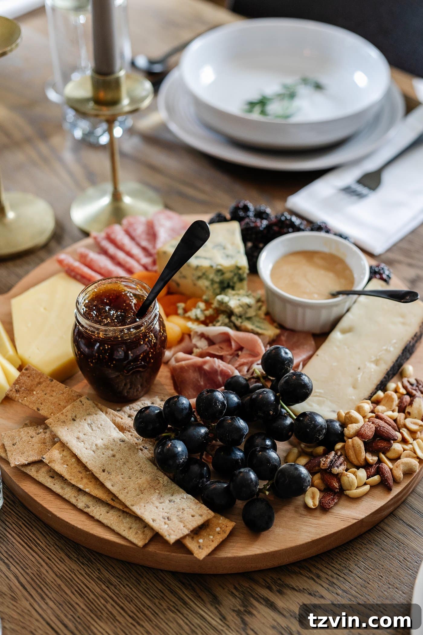 Effortless Table Settings for Every Occasion 15 charcuterie board with meats, cheeses, crackers, jams, fruit, nuts, and honey