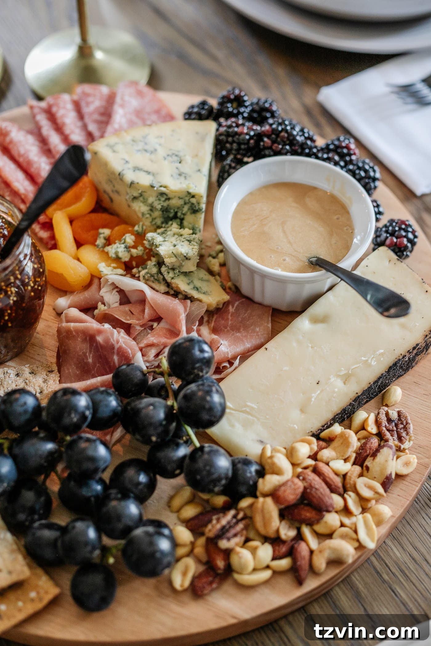 Effortless Table Settings for Every Occasion 16 charcuterie board with meats, cheeses, crackers, jams, fruit, nuts, and honey