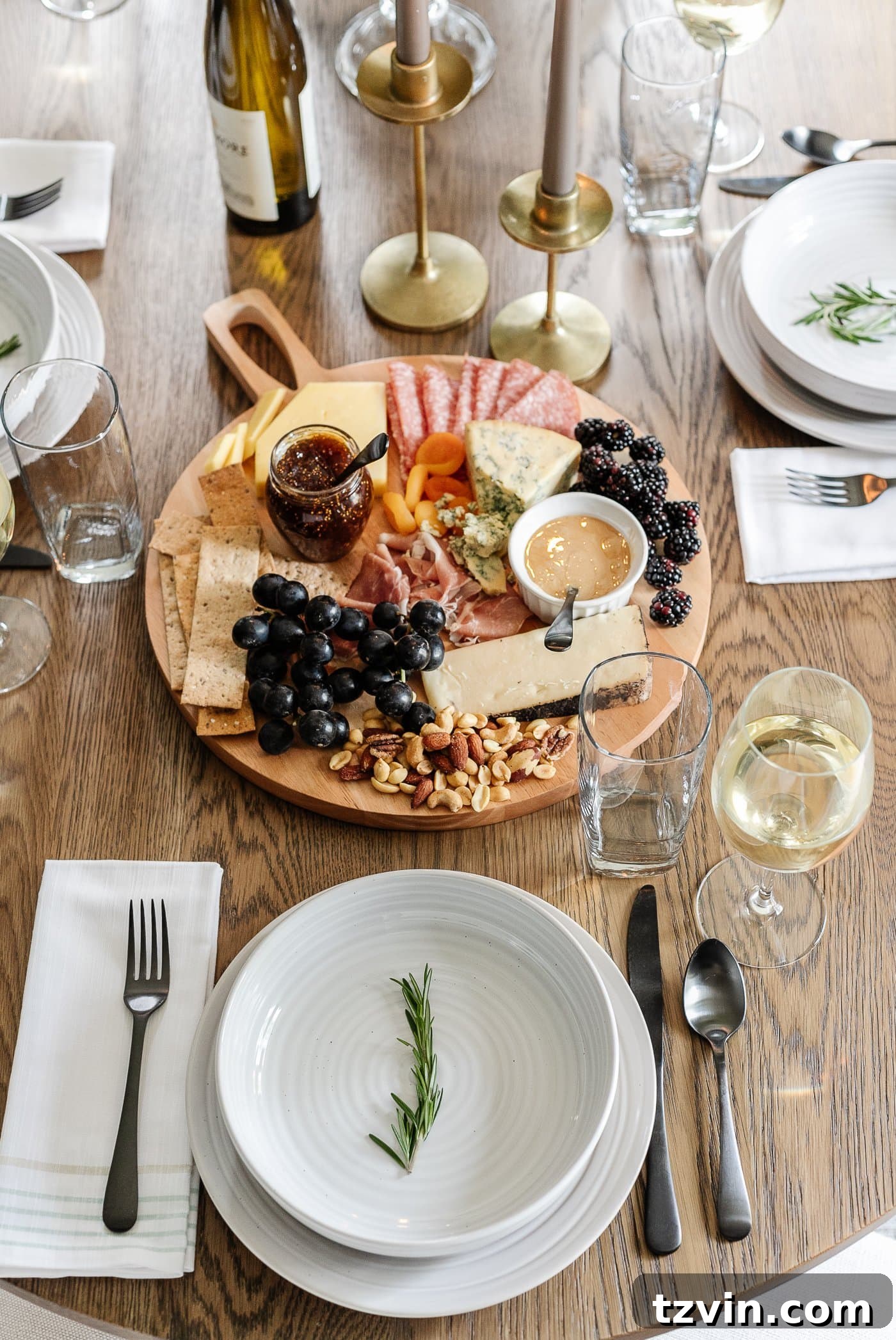 Effortless Table Settings for Every Occasion 6 charcuterie board and simple place setting with a rosemary sprig