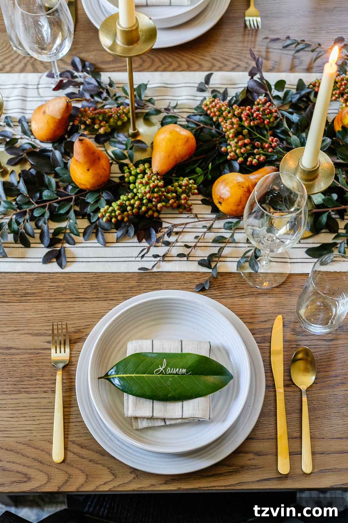 Effortless Table Settings for Every Occasion 7 fall place setting with magnolia leaf place card and low centerpiece using leaves and pears
