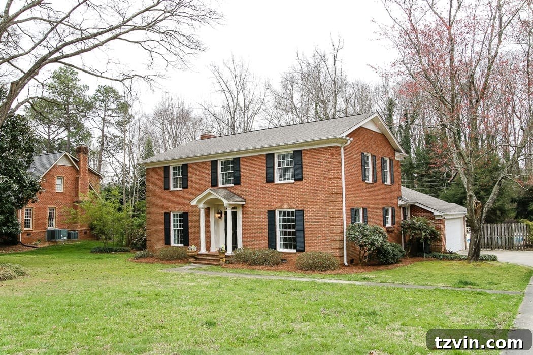 The original red brick colonial house exterior, showcasing its traditional, unpainted facade before renovation.
