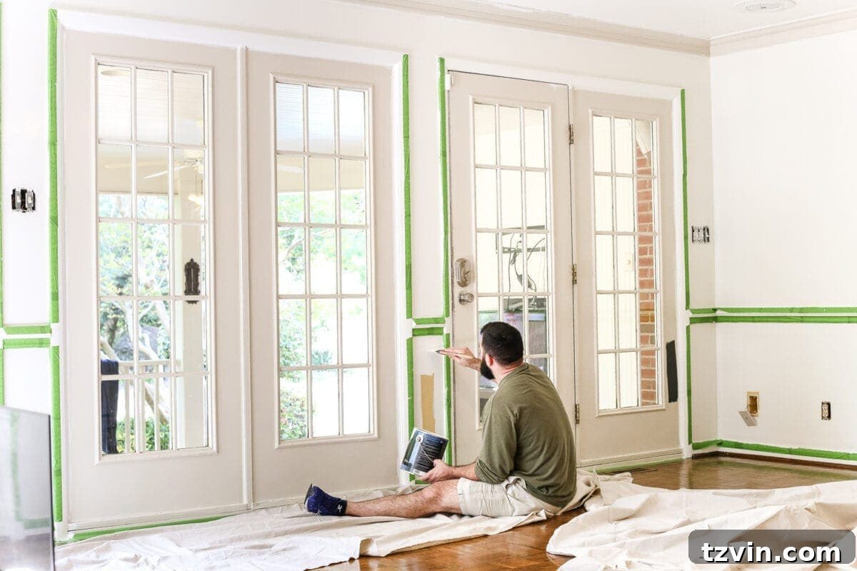 Before image of beige living room French doors, showcasing the original muted tones prior to a high-contrast transformation.
