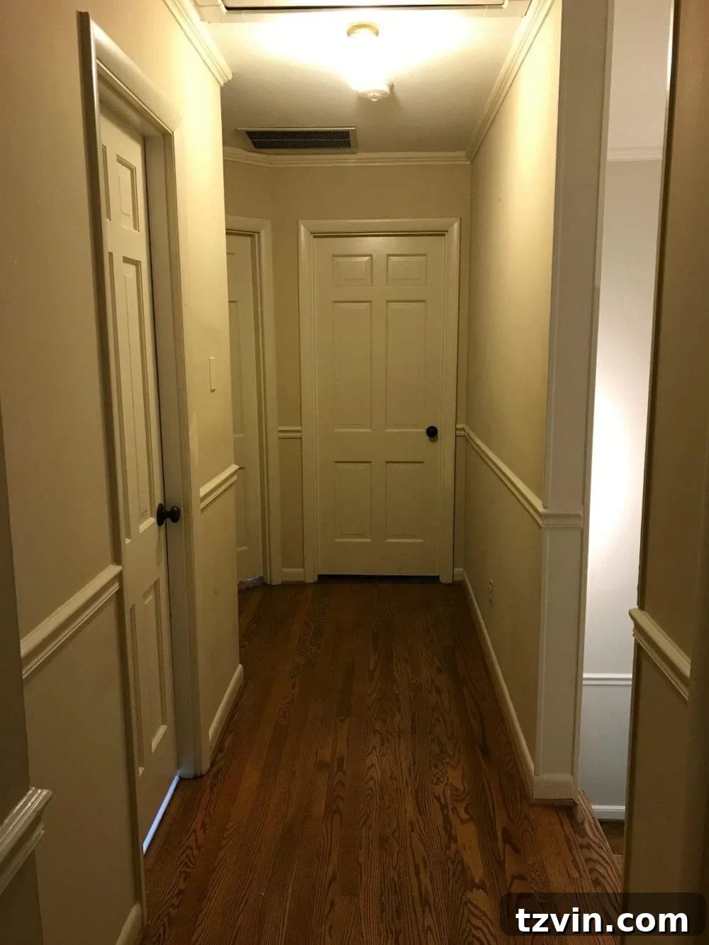 Before image of a generic beige hallway, awaiting a modern and bright home tour transformation.