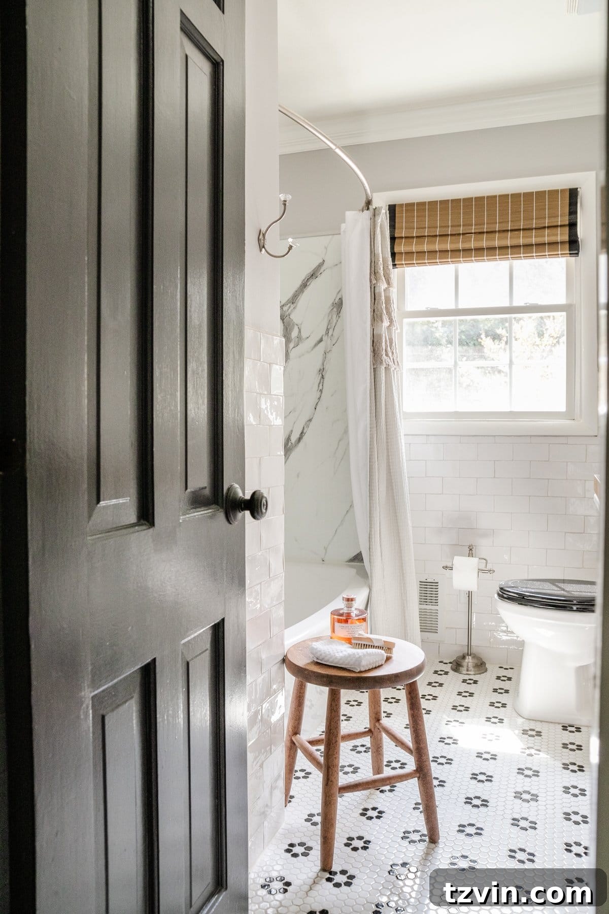 A chic gray, black, and white bathroom featuring a console table cleverly converted into a bathroom vanity, elegant subway tile walls, and a classic black and white retro tile floor, creating a sophisticated and functional space.