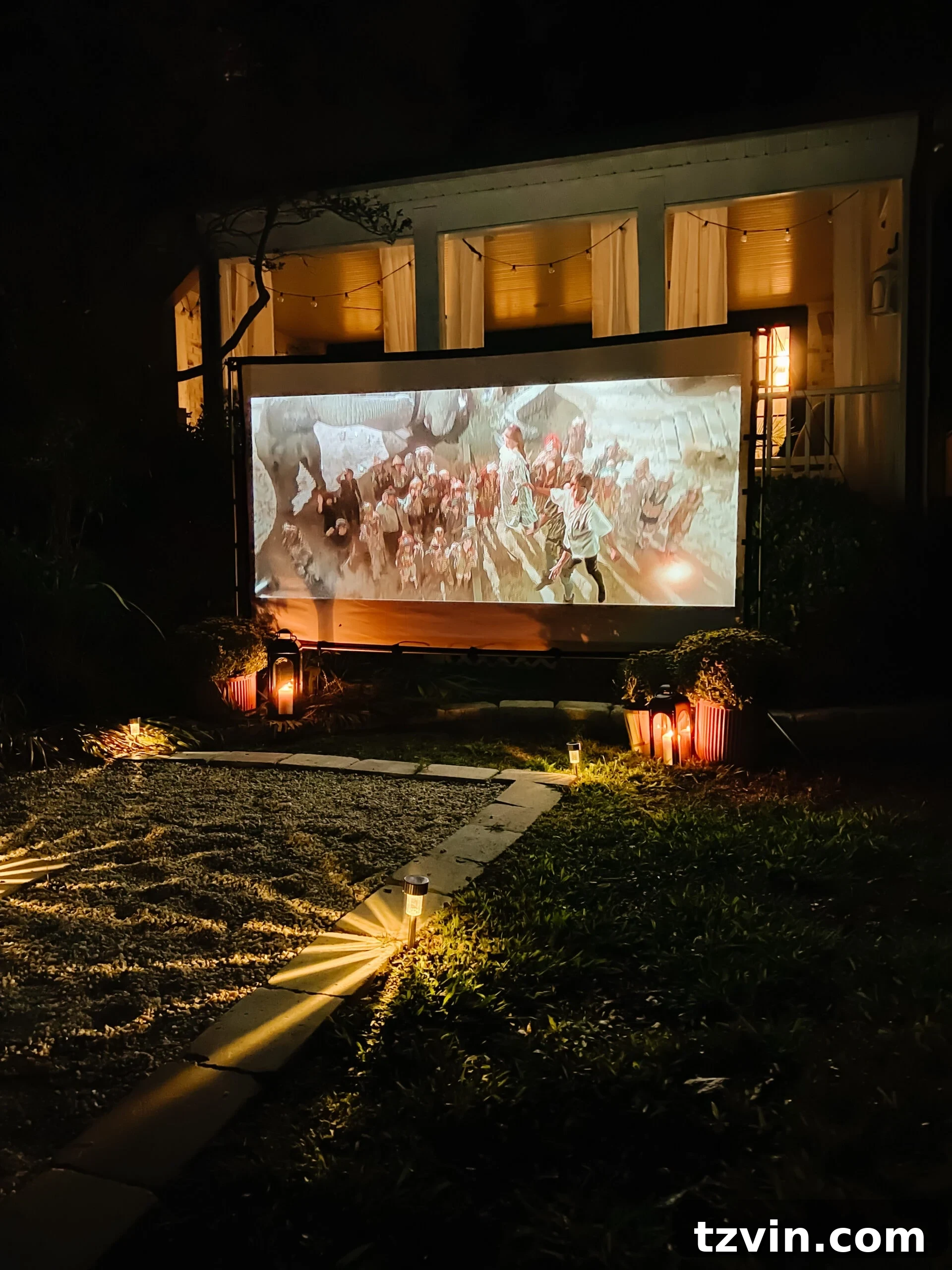 Under the Stars: 100 Must-Watch Movies for Your Backyard Cinema 5 an outdoor projector and movie screen setup in a backyard for a DIY outdoor cinema