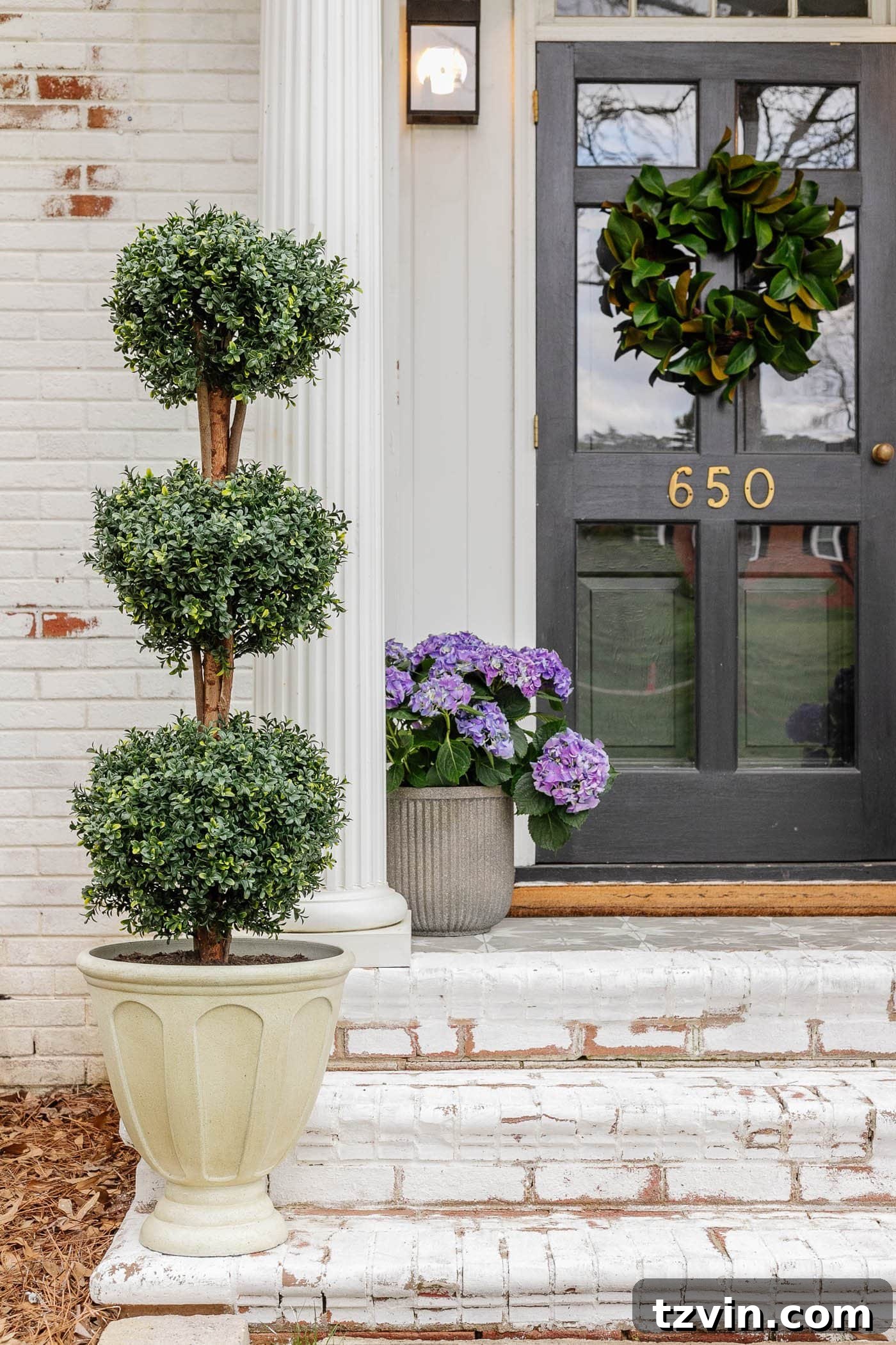 The Art of Creating Realistic Faux Trees 9 Outdoor urn planter filled with dirt and crushed bottles to make an artificial tree topiary look more realistic and stable against elements