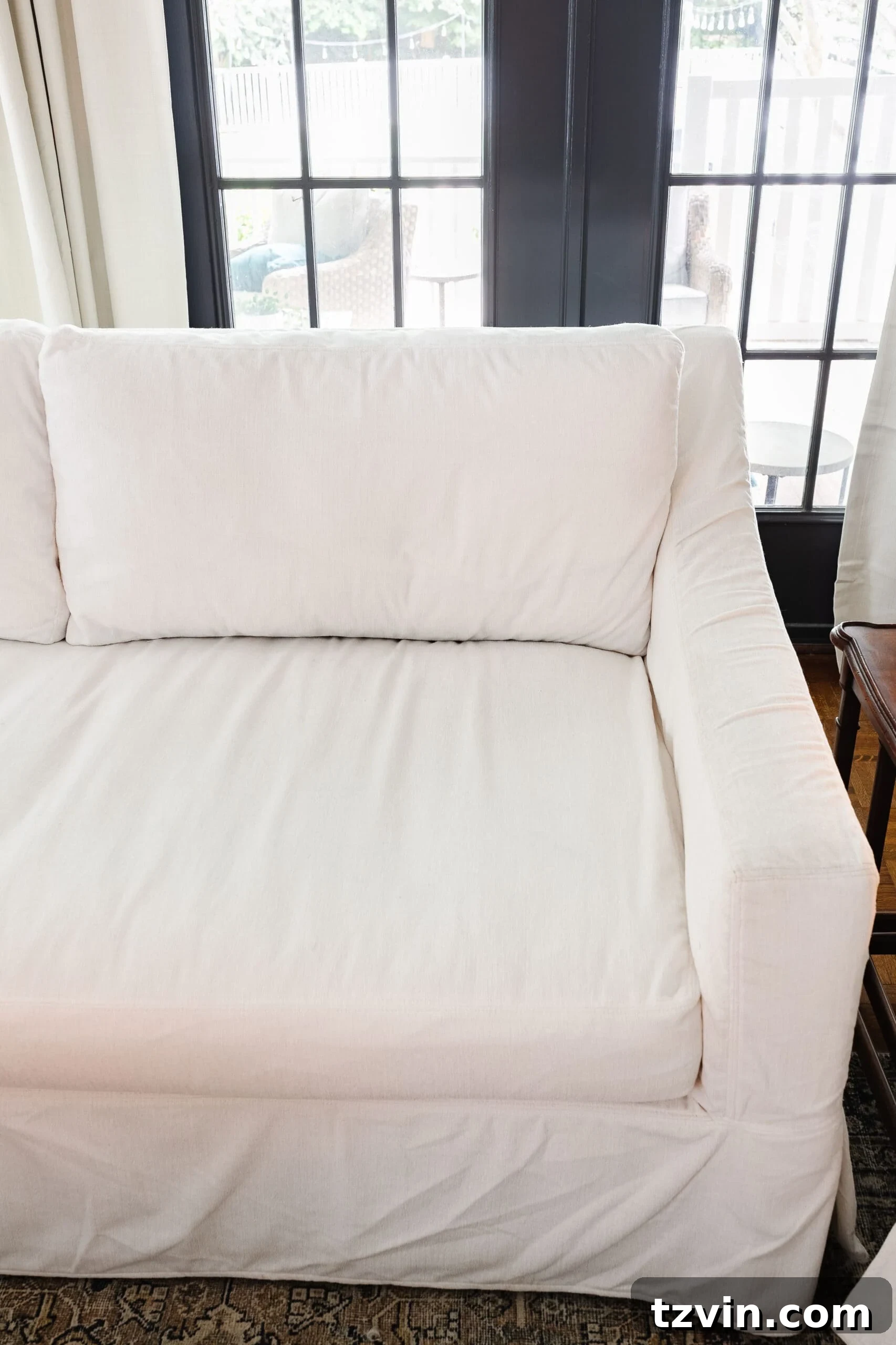 A beautifully clean couch with a crisp white slipcover, showcasing the results of the cleaning process.