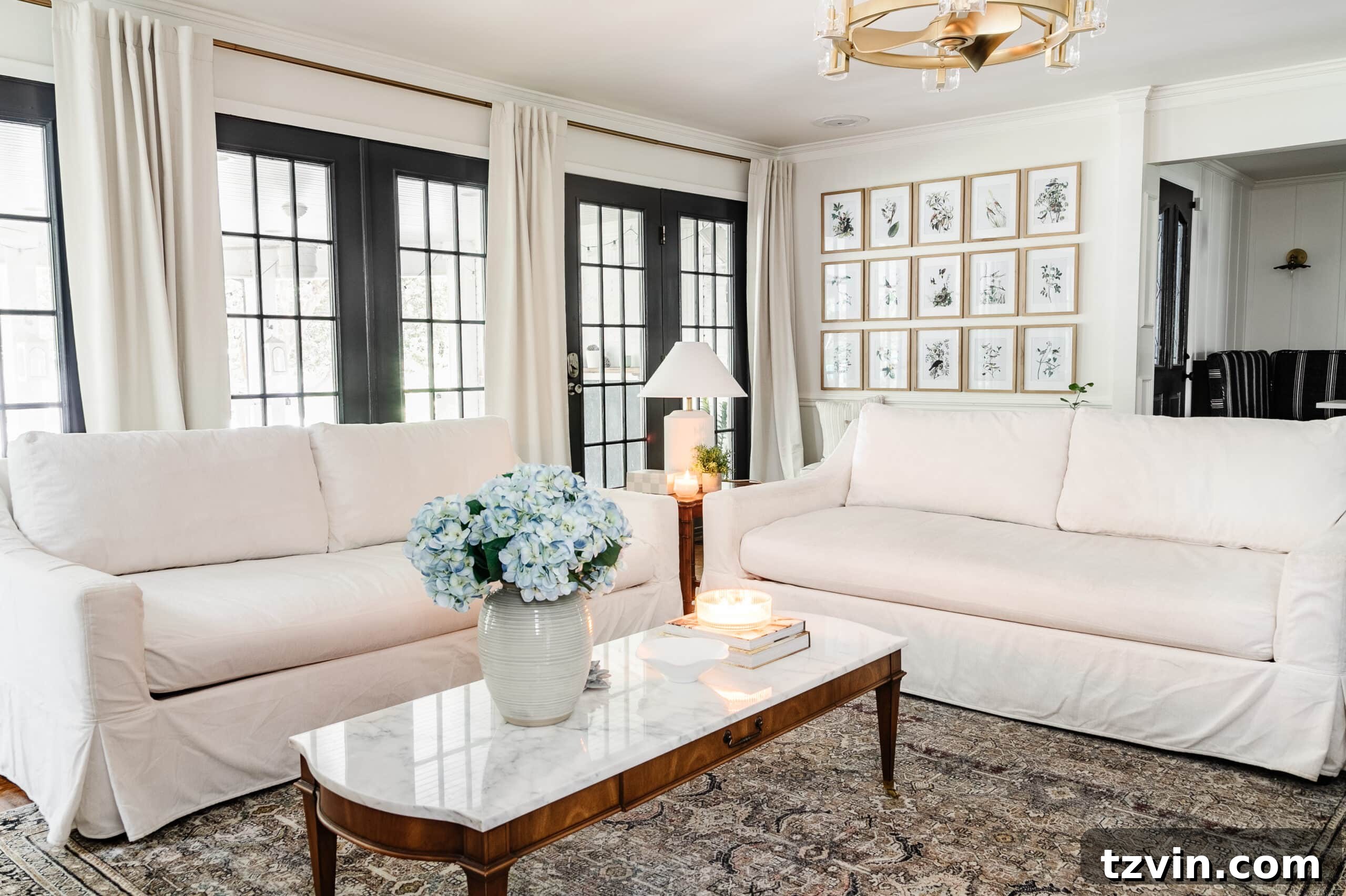 A bright and clean living room featuring white sofas with fresh slipcovers, demonstrating a well-maintained space.