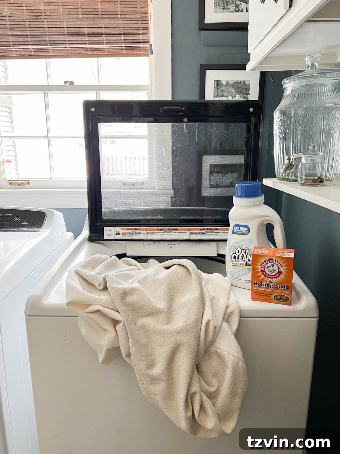 White cushion covers being washed in a washing machine for a full sofa cleaning.