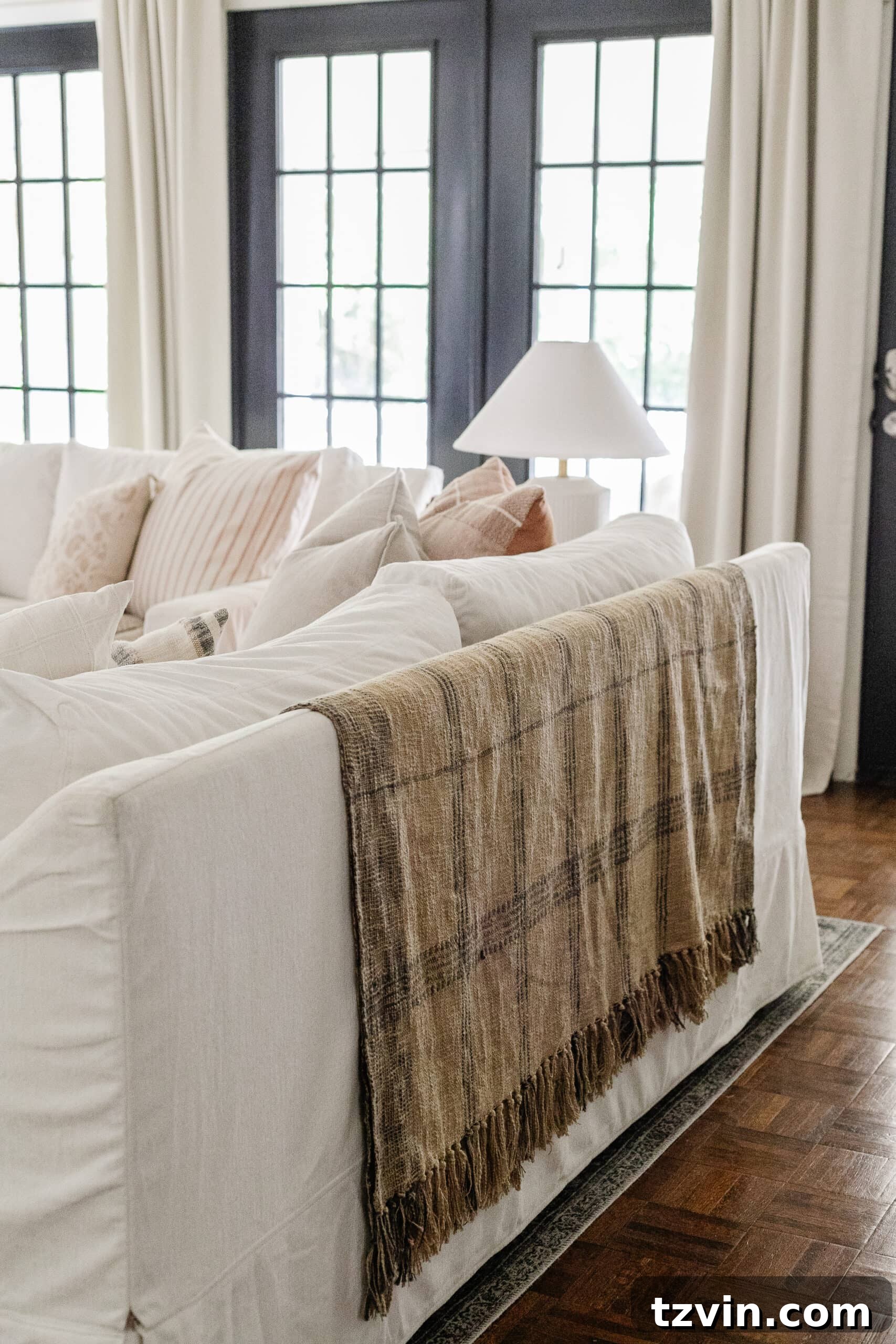 Effortless Autumn Living Room Decor for Less 17 Plaid throw blanket on back of couch