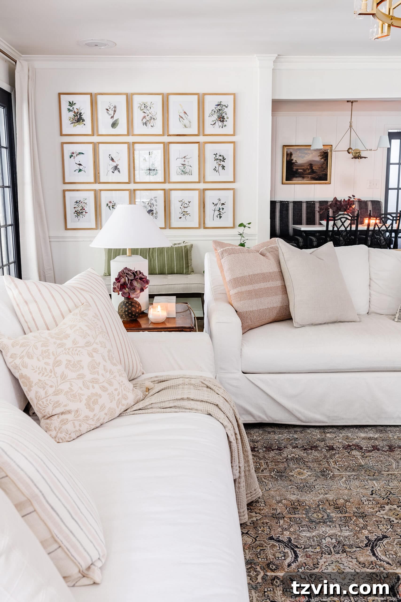 Effortless Autumn Living Room Decor for Less 23 Fall decorating ideas for living room with white sofas, lamps, and picture frame gallery wall
