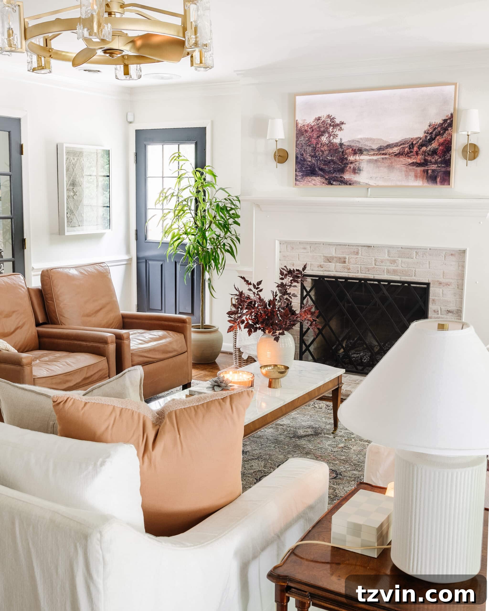 Effortless Autumn Living Room Decor for Less 24 Fall decorating ideas for a living room with vase of fall stems, fall art on a TV, and leather recliners