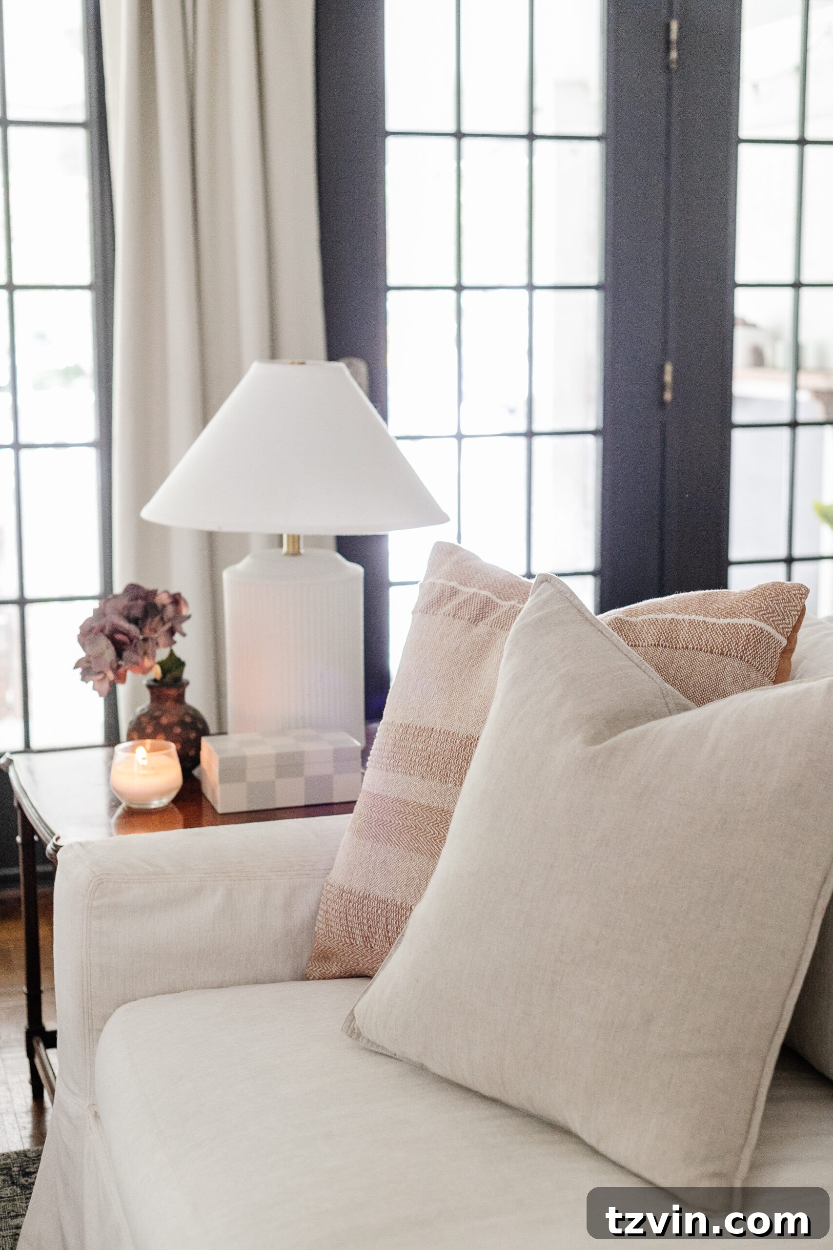 Effortless Autumn Living Room Decor for Less 9 Neutral throw pillows on a white couch with subtle end table decor and lamp