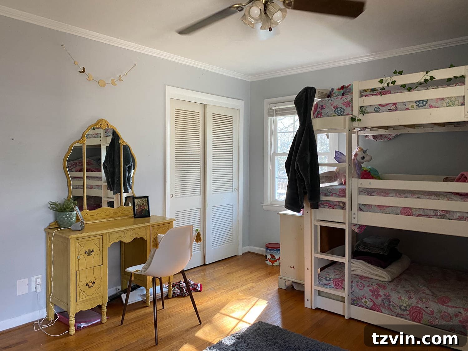 Shared teenage bedroom before, showing a triple bunk bed in a plain corner