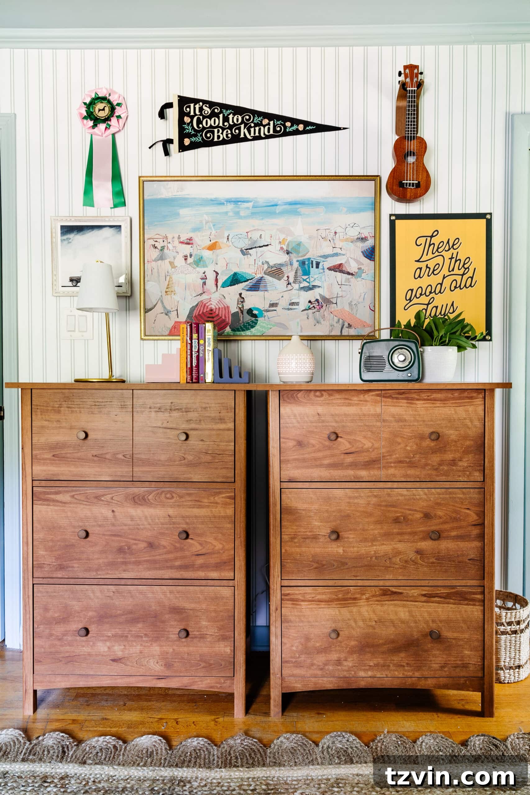 Vintage gallery wall in a teenage bedroom above dressers, featuring coastal paintings and camp art