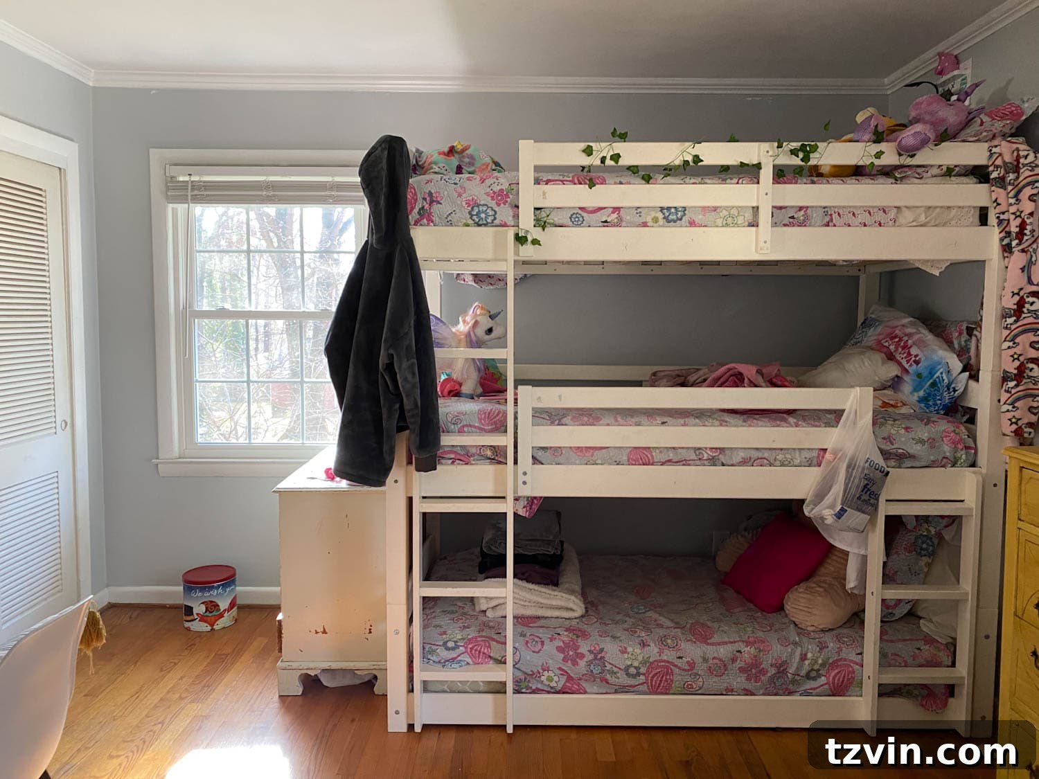 Triple bunk bed in a shared teenage bedroom before its makeover