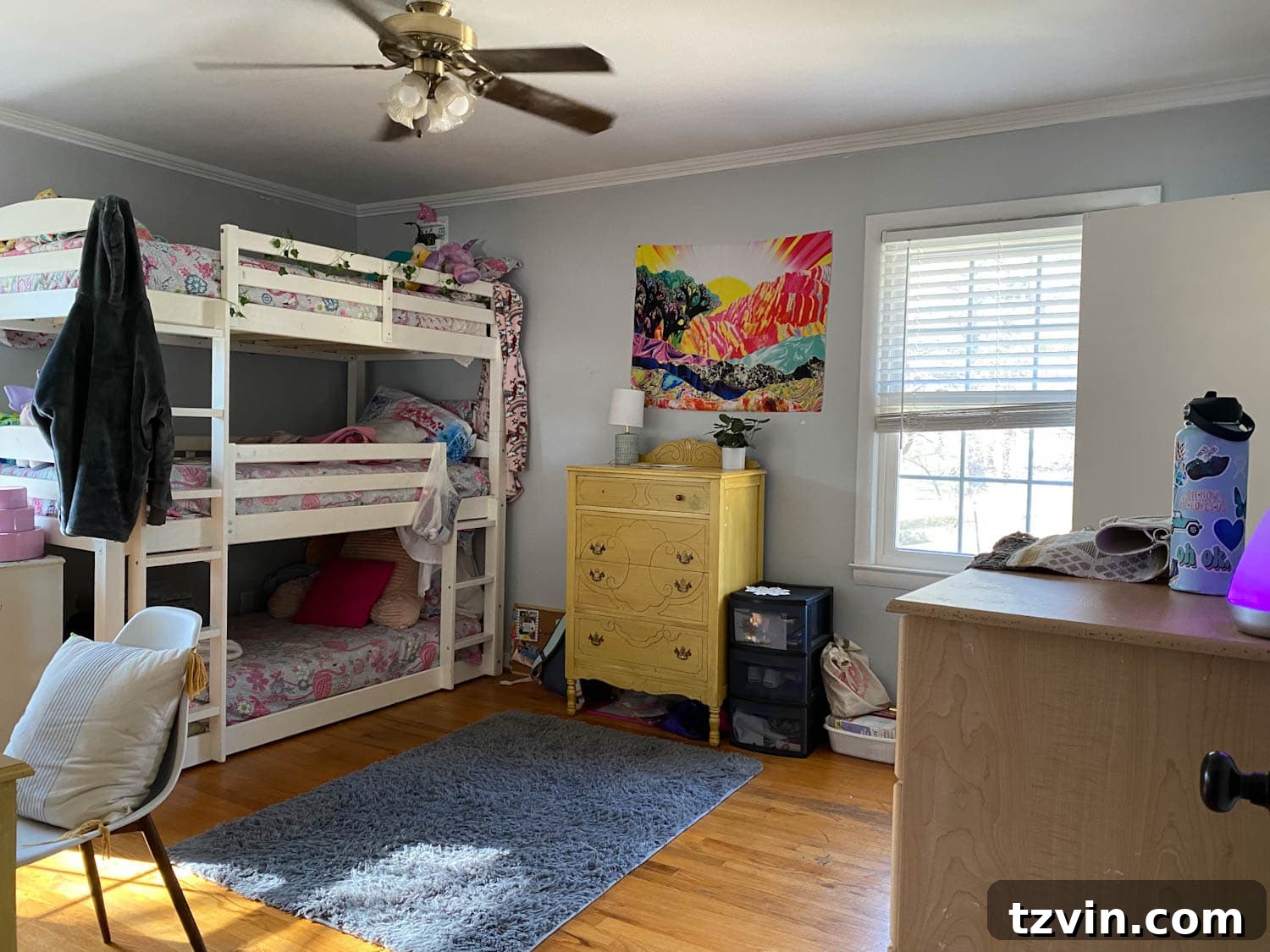 Before shot of a cramped triple bunk bed in a shared teenage bedroom
