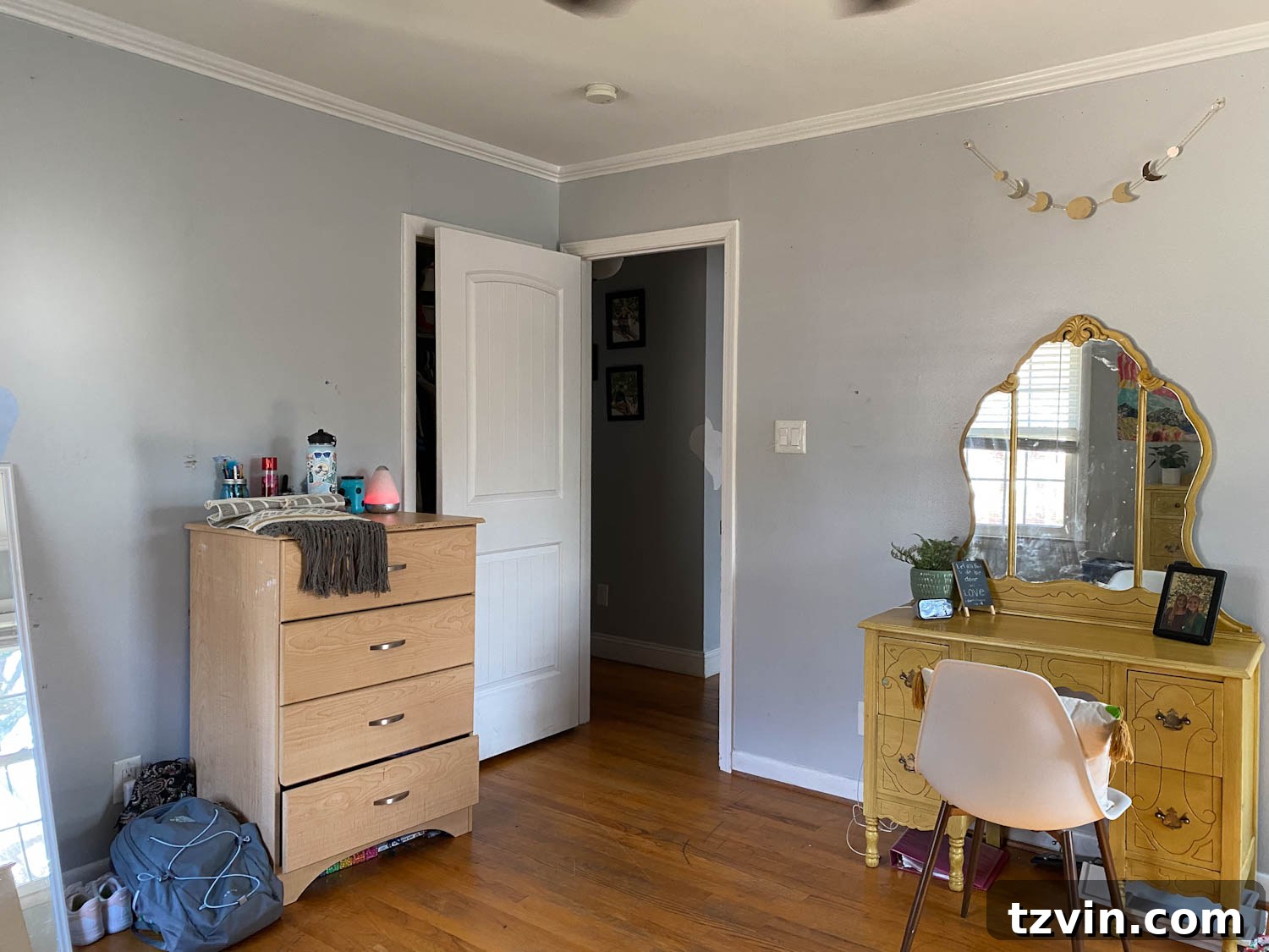 Shared teenage bedroom before, showing a dresser and small desk vanity