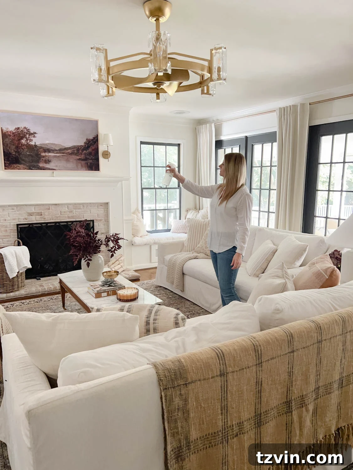 spritzing room spray in a living room 