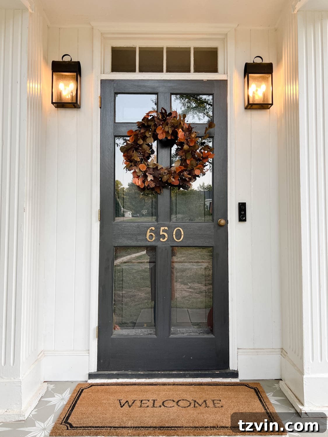 Harvesting Realism: The Top Fake Pumpkins of 2024 3 A close-up of a front door featuring a beautifully realistic artificial fall wreath, adding a touch of autumn elegance to the entrance.