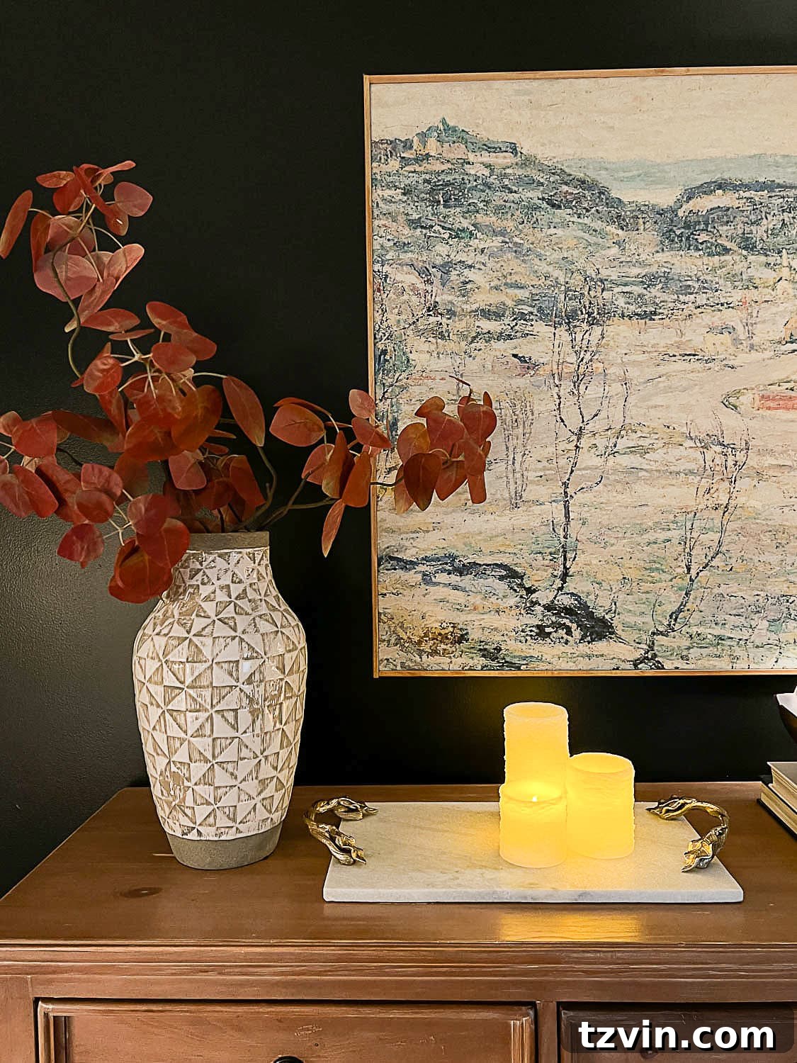 10 Budget-Friendly Ways to Create a Cozy Sleep Haven 10 flameless candles, marble tray, vase of fall branches and large wall art on top of dresser