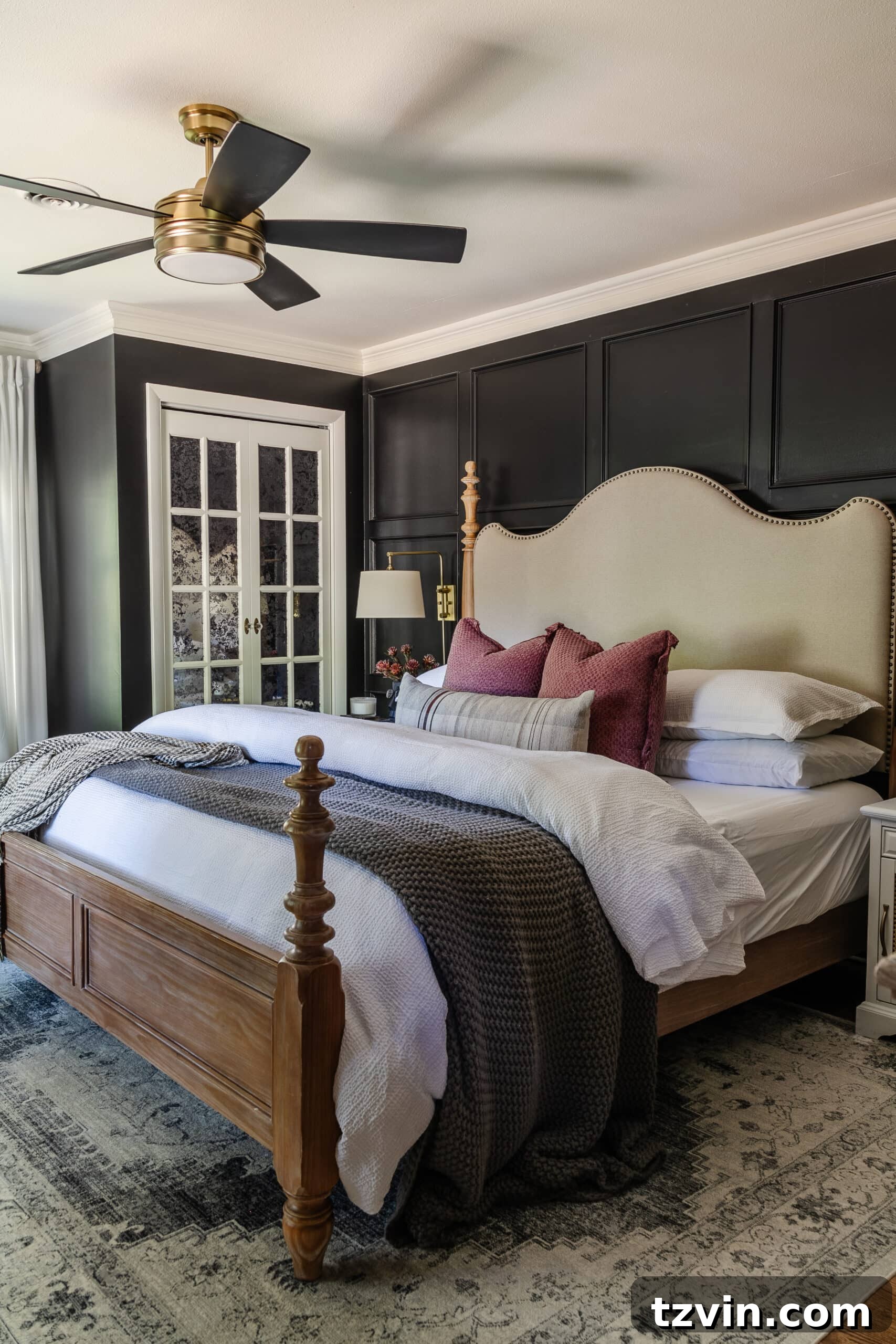 10 Budget-Friendly Ways to Create a Cozy Sleep Haven 5 bedroom with black walls, fluffy bedding, wood and upholstered bed, and ceiling fan