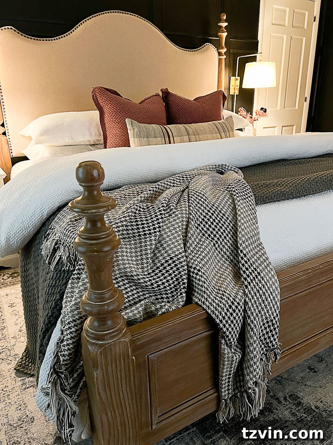 10 Budget-Friendly Ways to Create a Cozy Sleep Haven 8 wood and upholstered bed with mauve pillows and houndstooth blanket