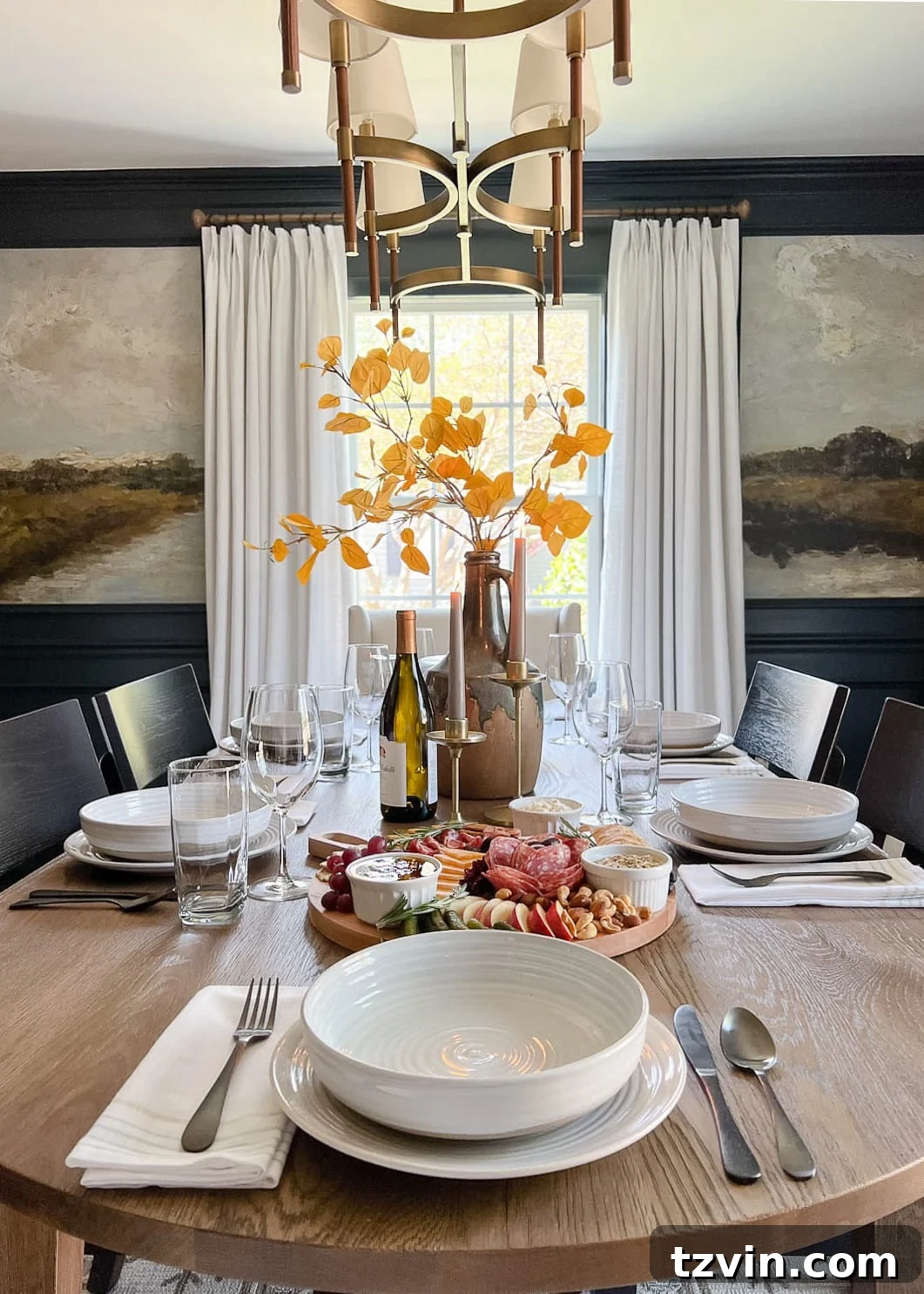 dinner table setting with fall centerpiece vase with fall branches and candles 