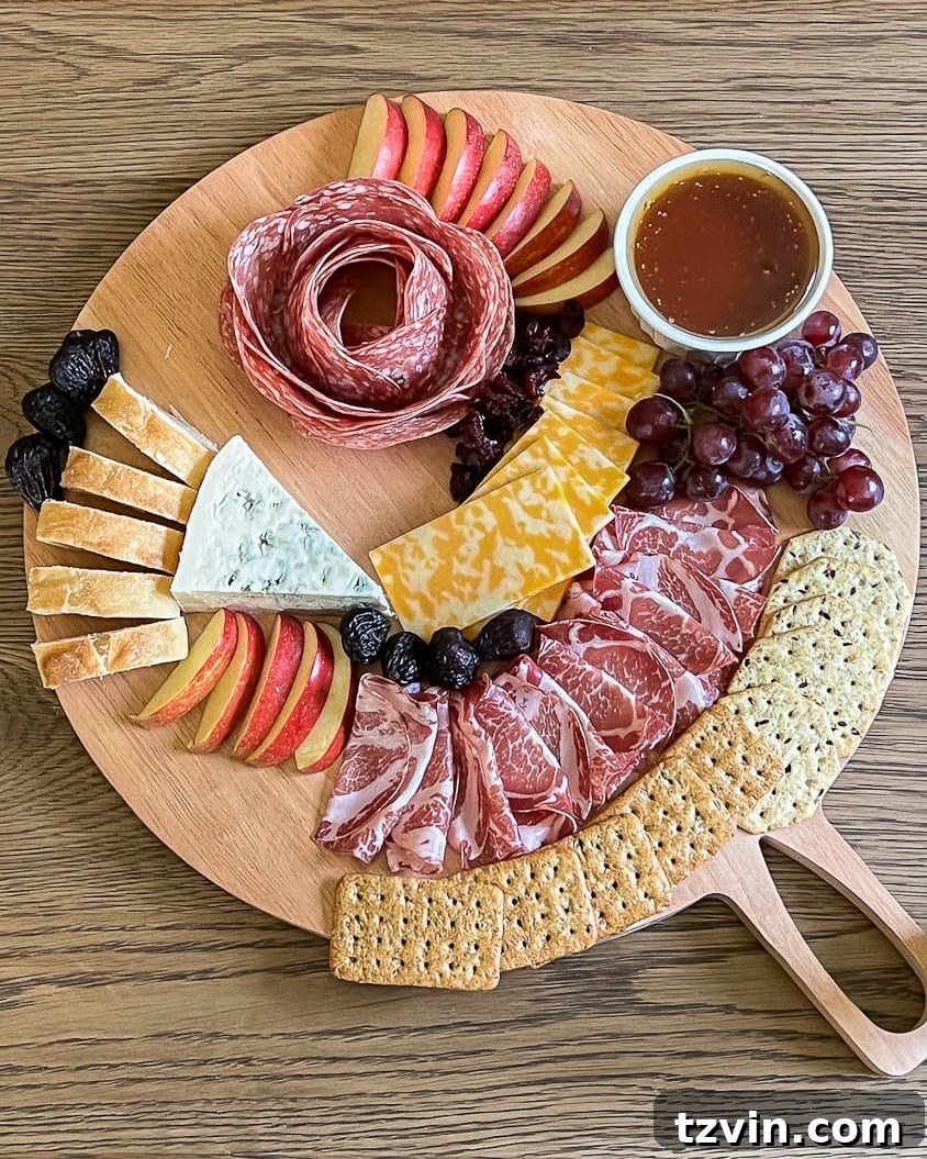 10-Minute Charcuterie Board Hack 7 A charcuterie board now featuring an array of sweet ingredients including fresh grapes, berries, and a small bowl of jam.