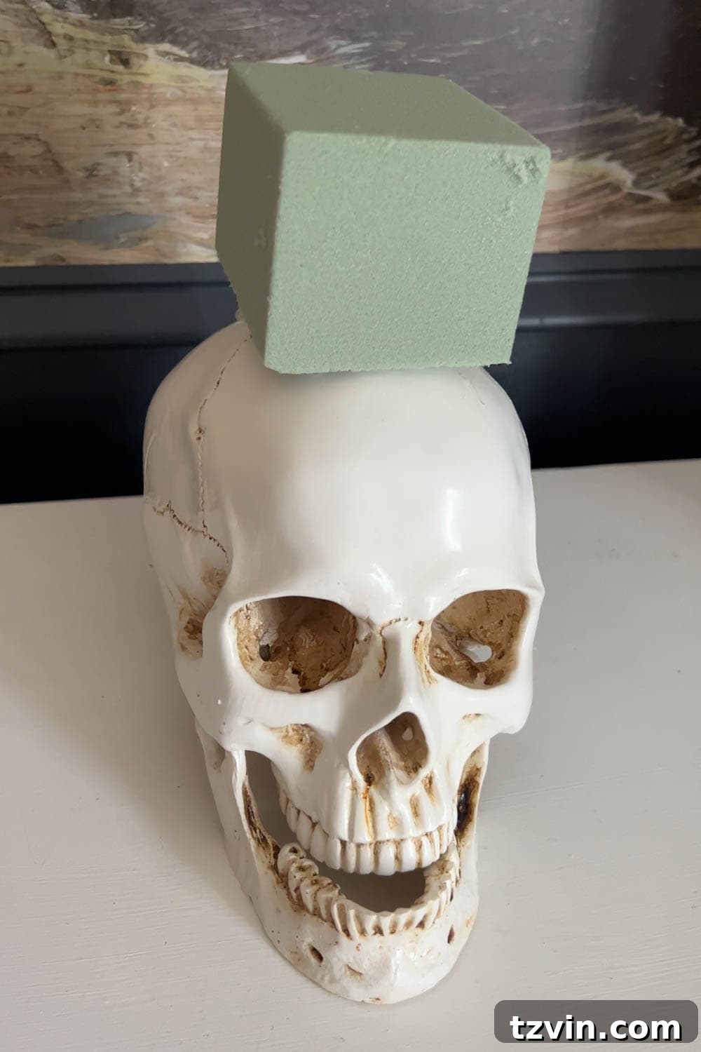 DIY Foyer Frights: Haunted Halloween Welcome 5 fake skull with floral block foam on top