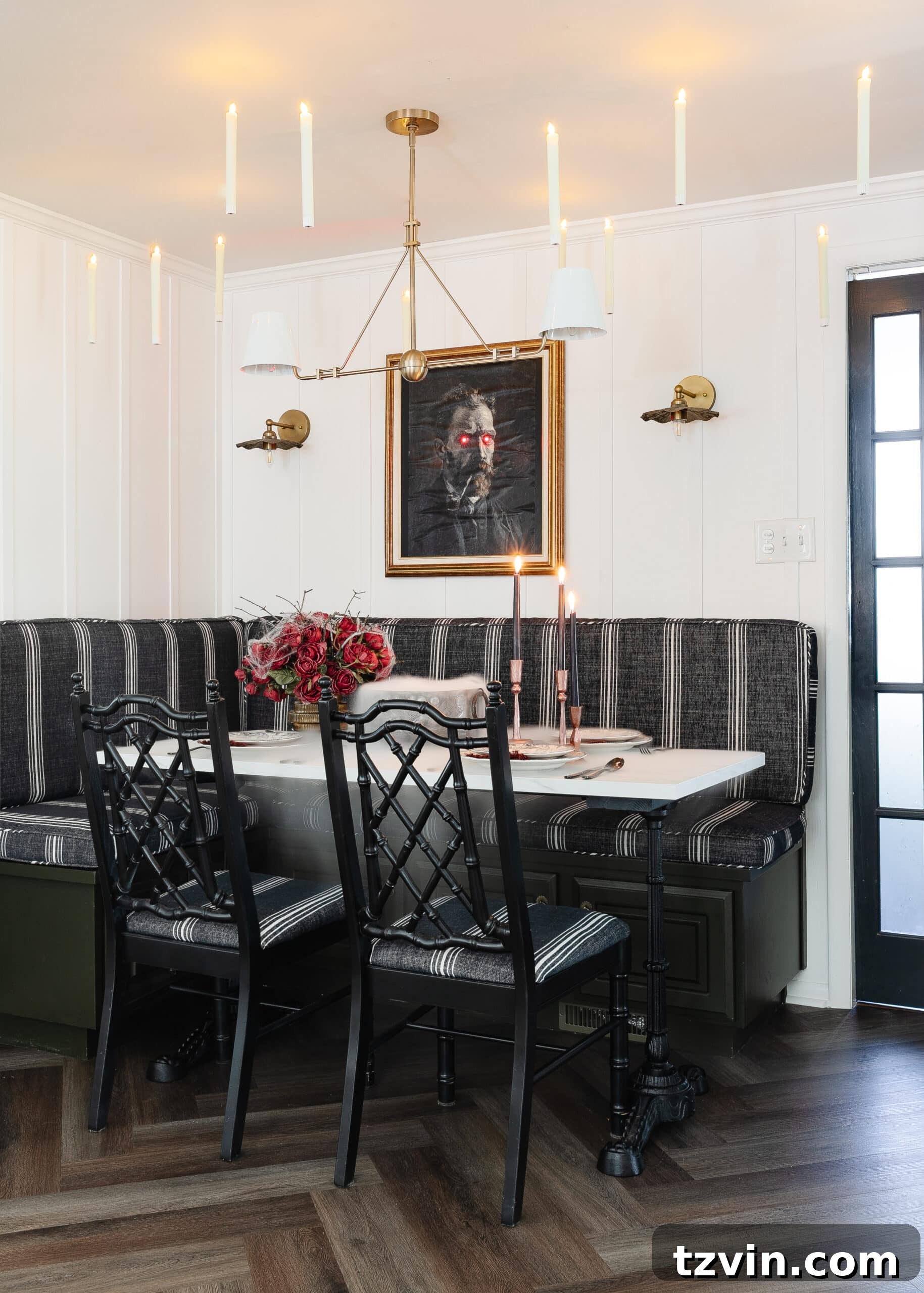 Killer Tablescapes: Spooky Settings for Your Murder Mystery Party 2 Halloween table decor ideas for a murder mystery dinner party with Halloween art portrait, floating candles, and dinnerware