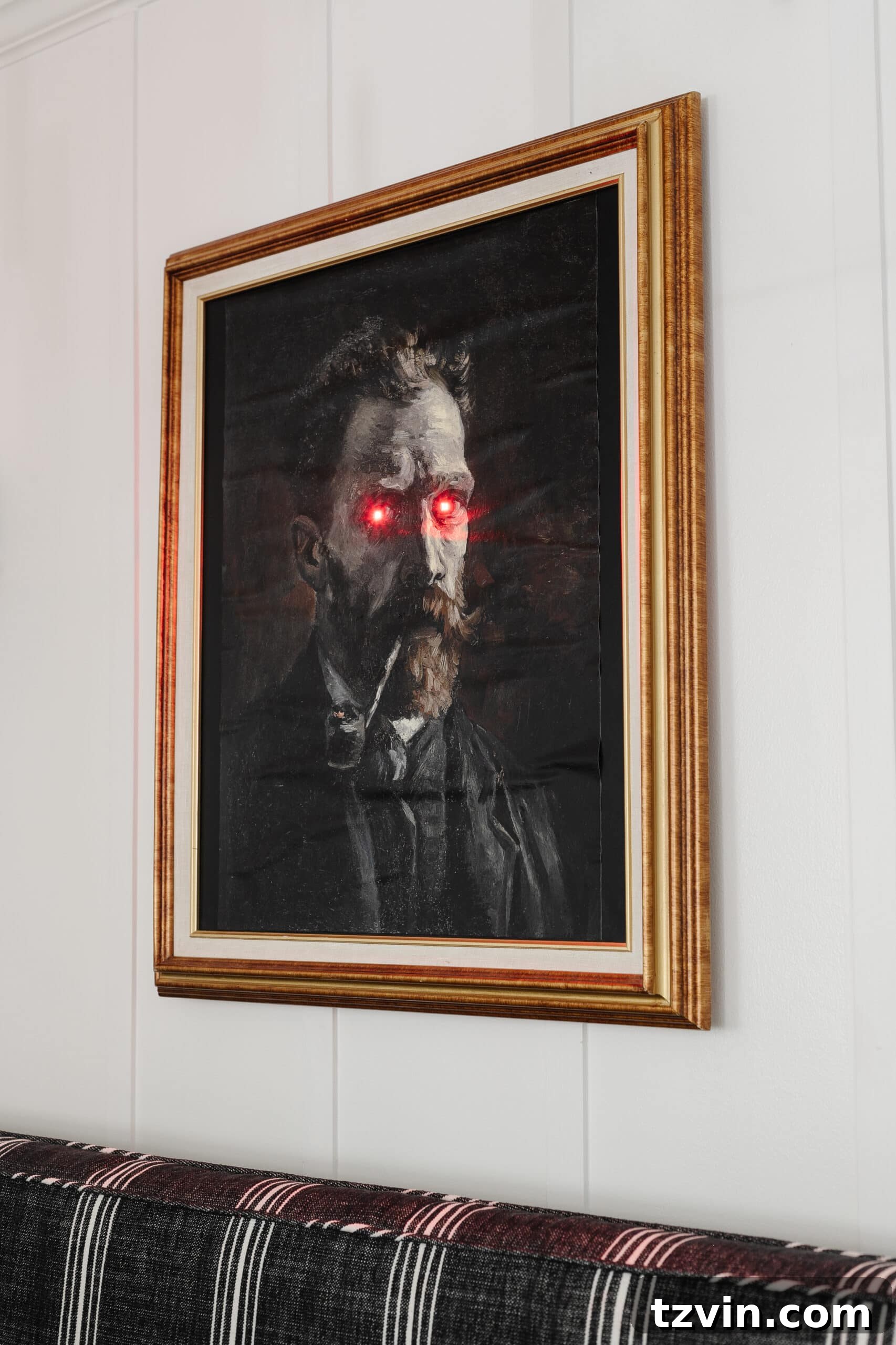 creepy Halloween art with glowing eyes in a gold picture frame for DIY Halloween wall decor