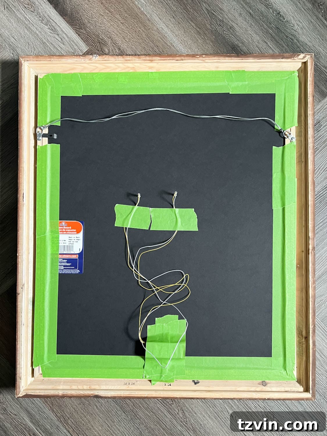 red battery lights taped to the back of a Halloween art portrait