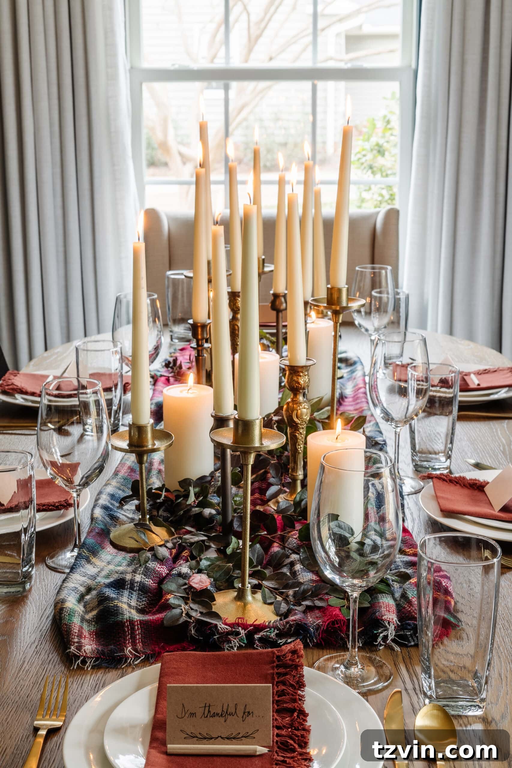 cheap Thanksgiving centerpiece idea using a scarf, candlesticks, dollar store candles, and cut stems
