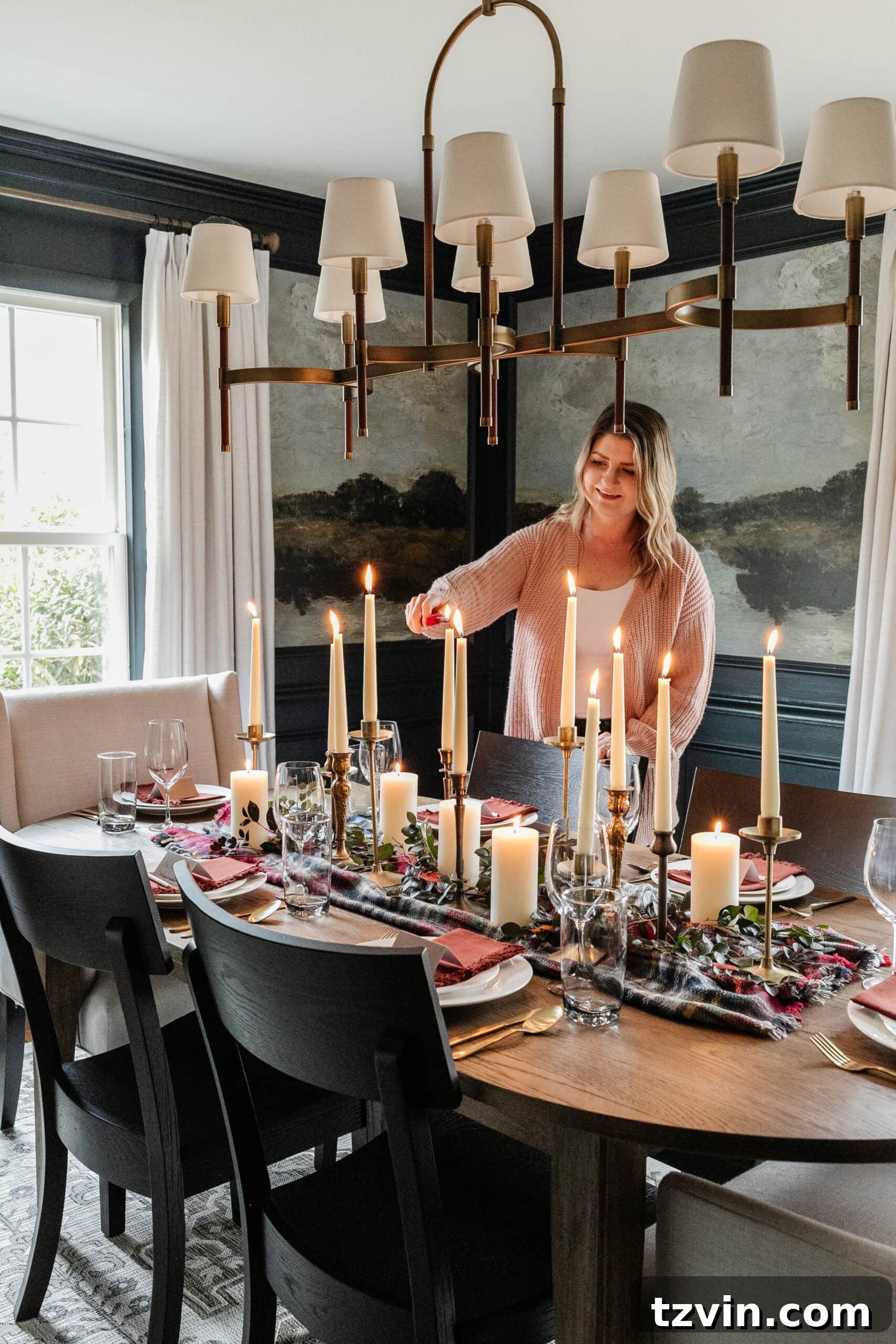 lighting candles on a set Thanksgiving table