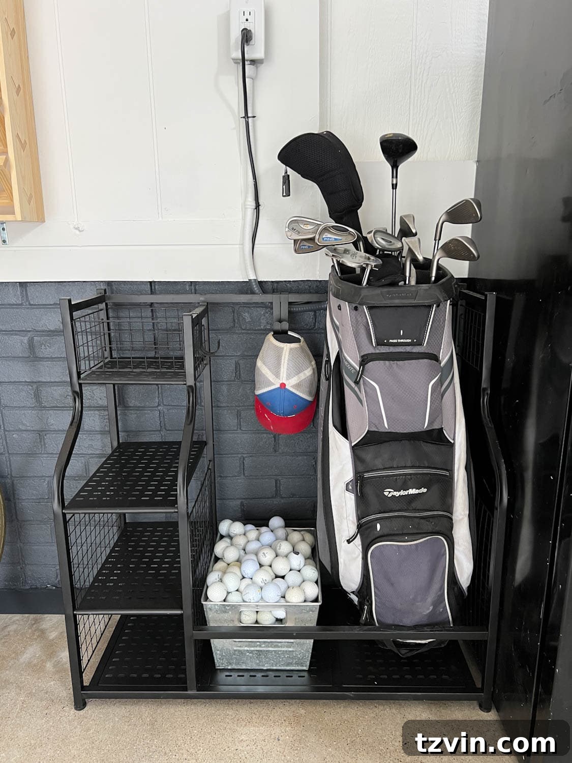 A golf storage rack neatly placed against a wall in the organized garage, holding golf bags and accessories.