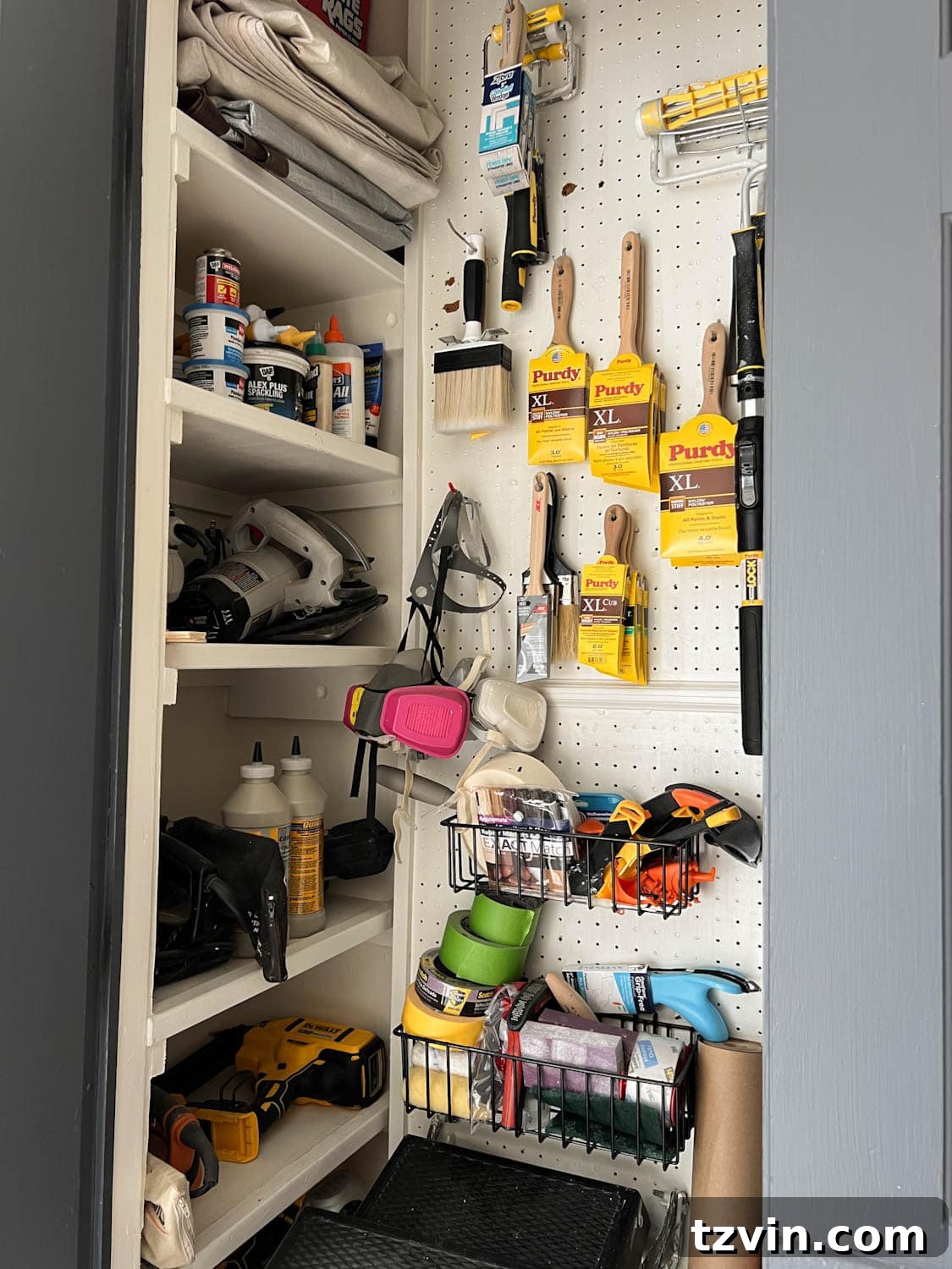 Detailed view of paint storage closet organization, showcasing pegboard with hooks and baskets for various supplies.