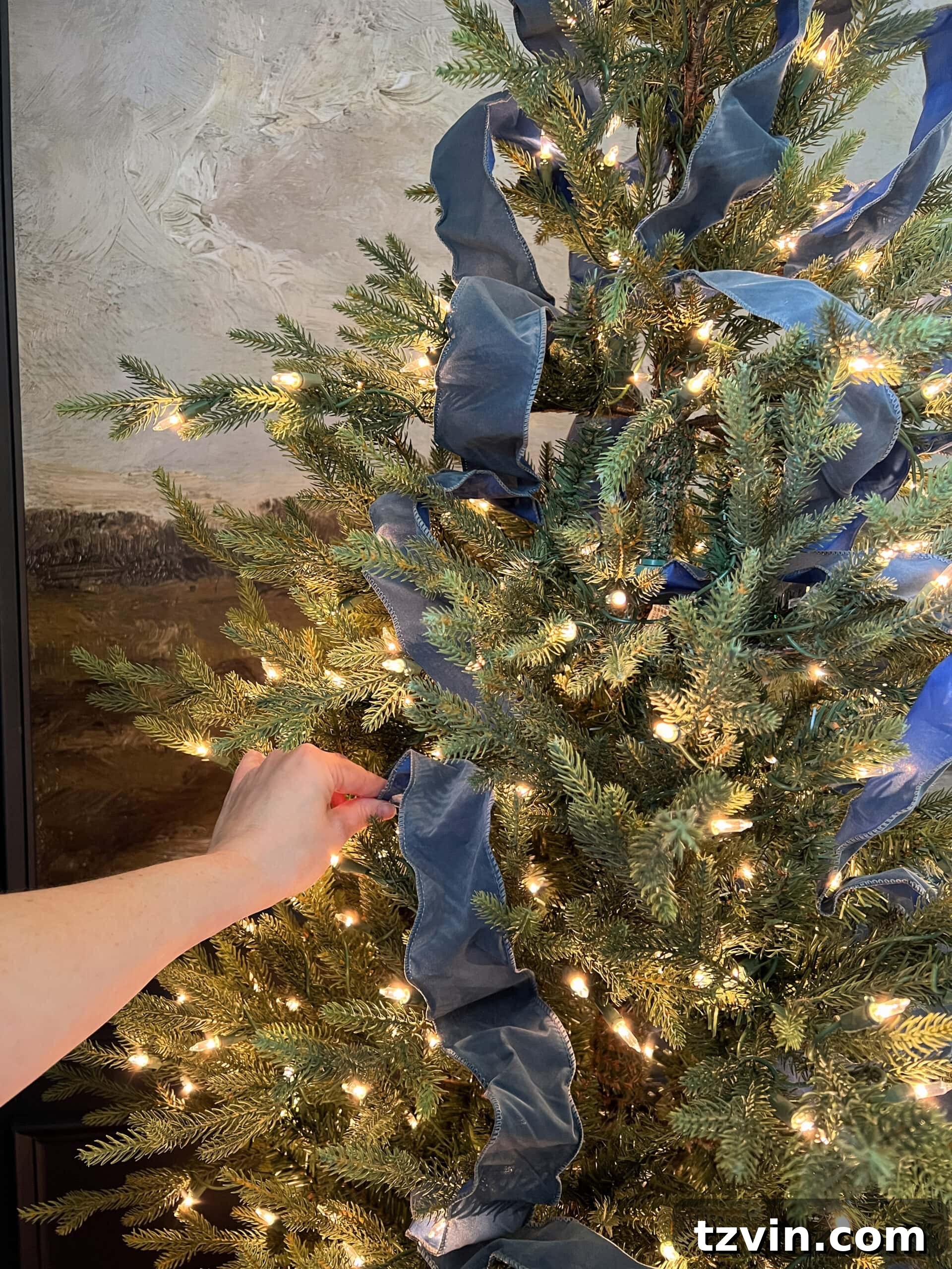 how to put on Christmas tree ribbon by tucking in pieces in a weaving pattern