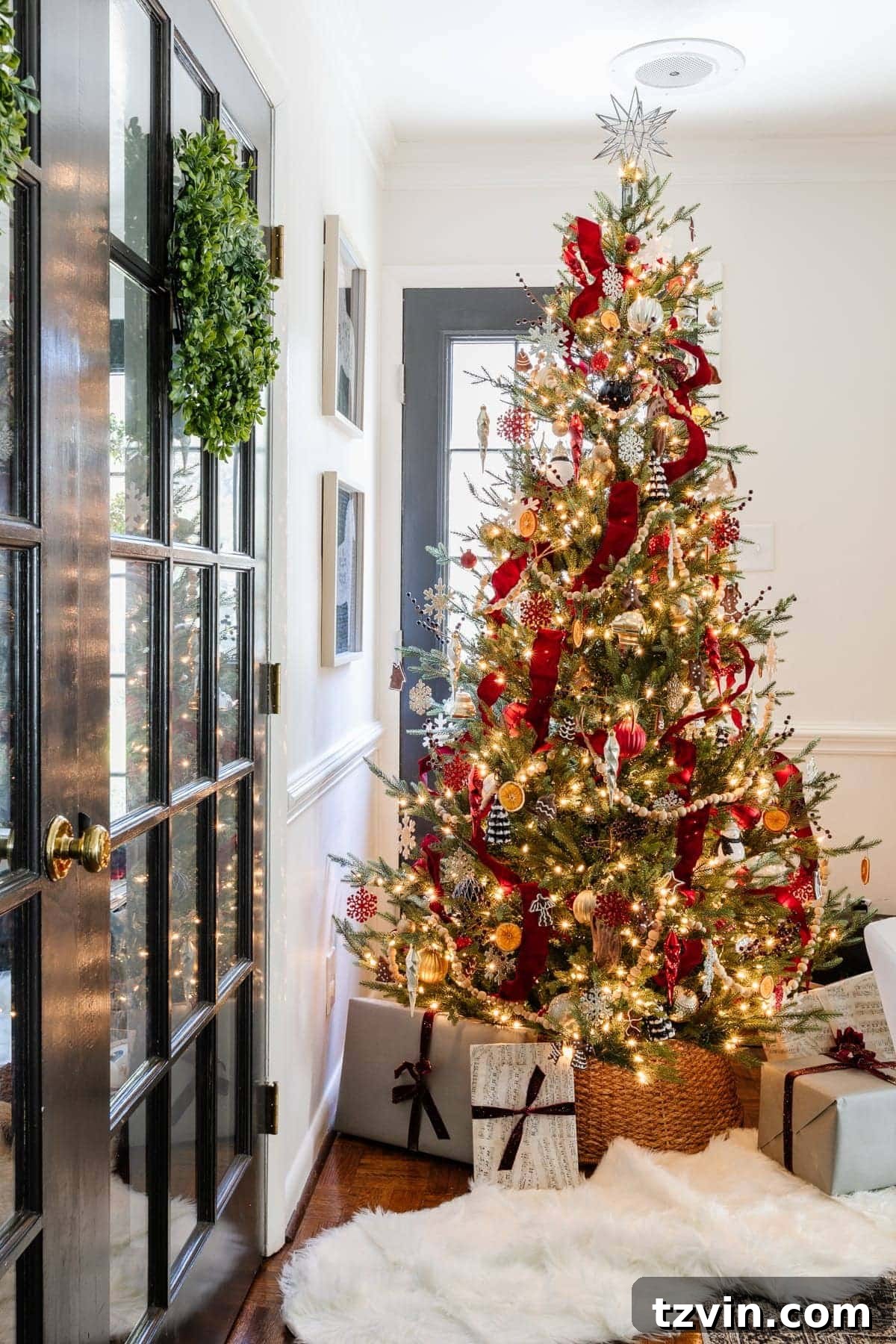 Christmas tree decorating with red tree ribbon