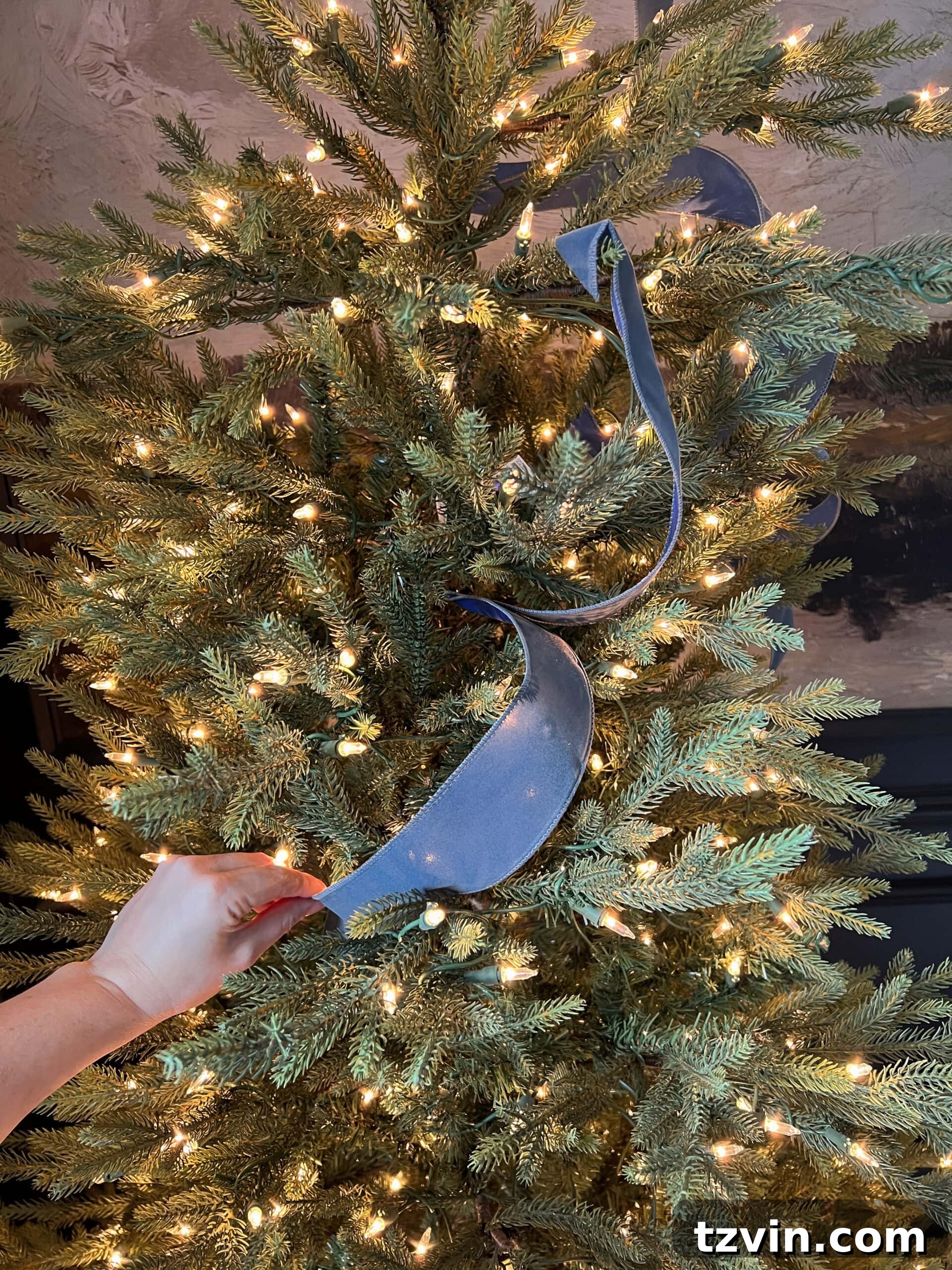 tucking ribbon piece between branches