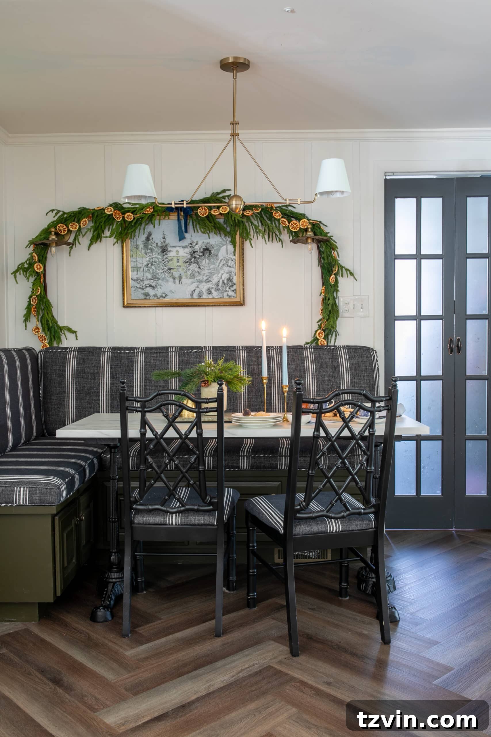 Instant Winter Art: Free Printable Decor 9 Cozy breakfast nook decorated for Christmas with a charming garland and beautiful snow art on the wall.