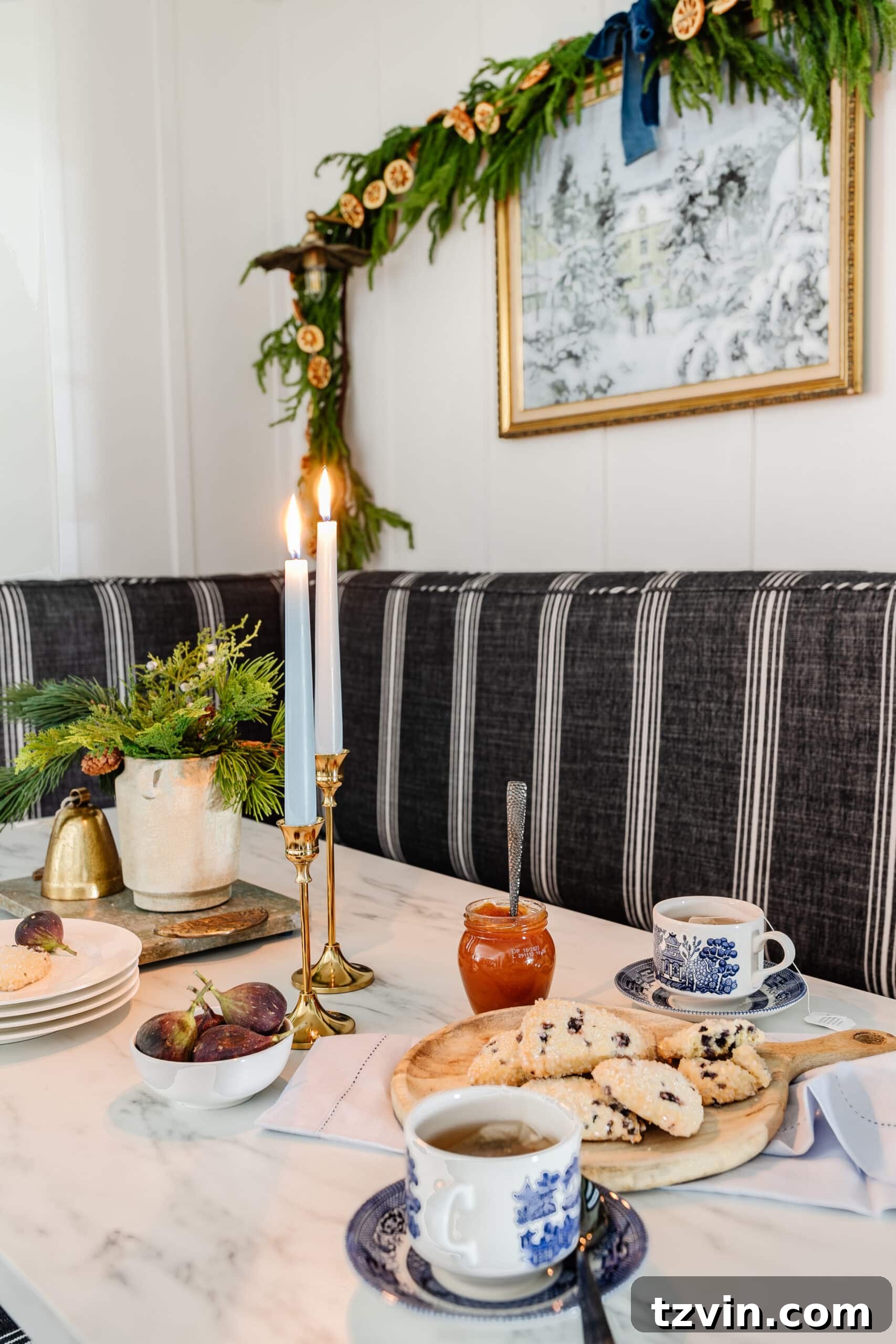 Instant Winter Art: Free Printable Decor 7 Festive Christmas kitchen table featuring a vase of fresh winter greenery, a captivating winter painting, and an elegant garland.