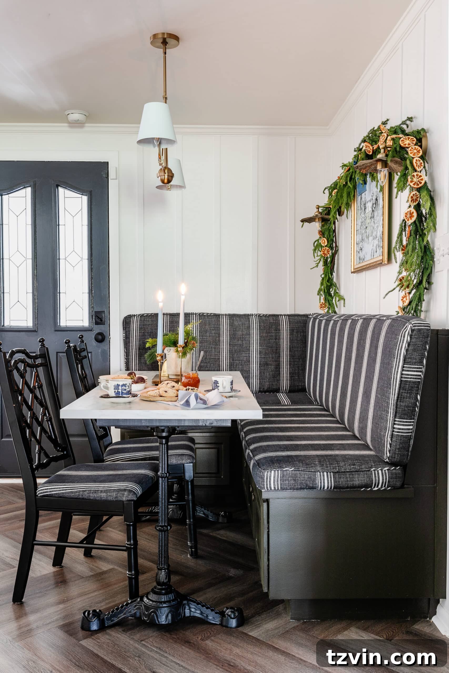 Instant Winter Art: Free Printable Decor 8 Breakfast nook with a comfortable banquette and kitchen table, elegantly decorated for Christmas with a vase of winter stems.