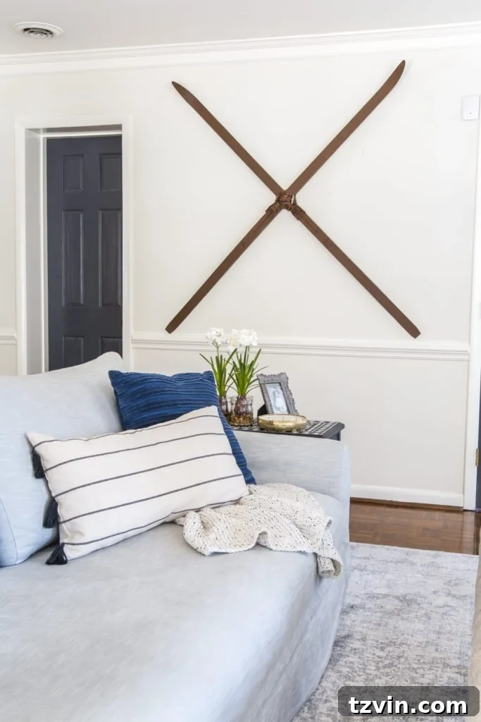 Creative Christmas wall decor idea utilizing charming snow skis thoughtfully hung on a wall for a rustic touch
