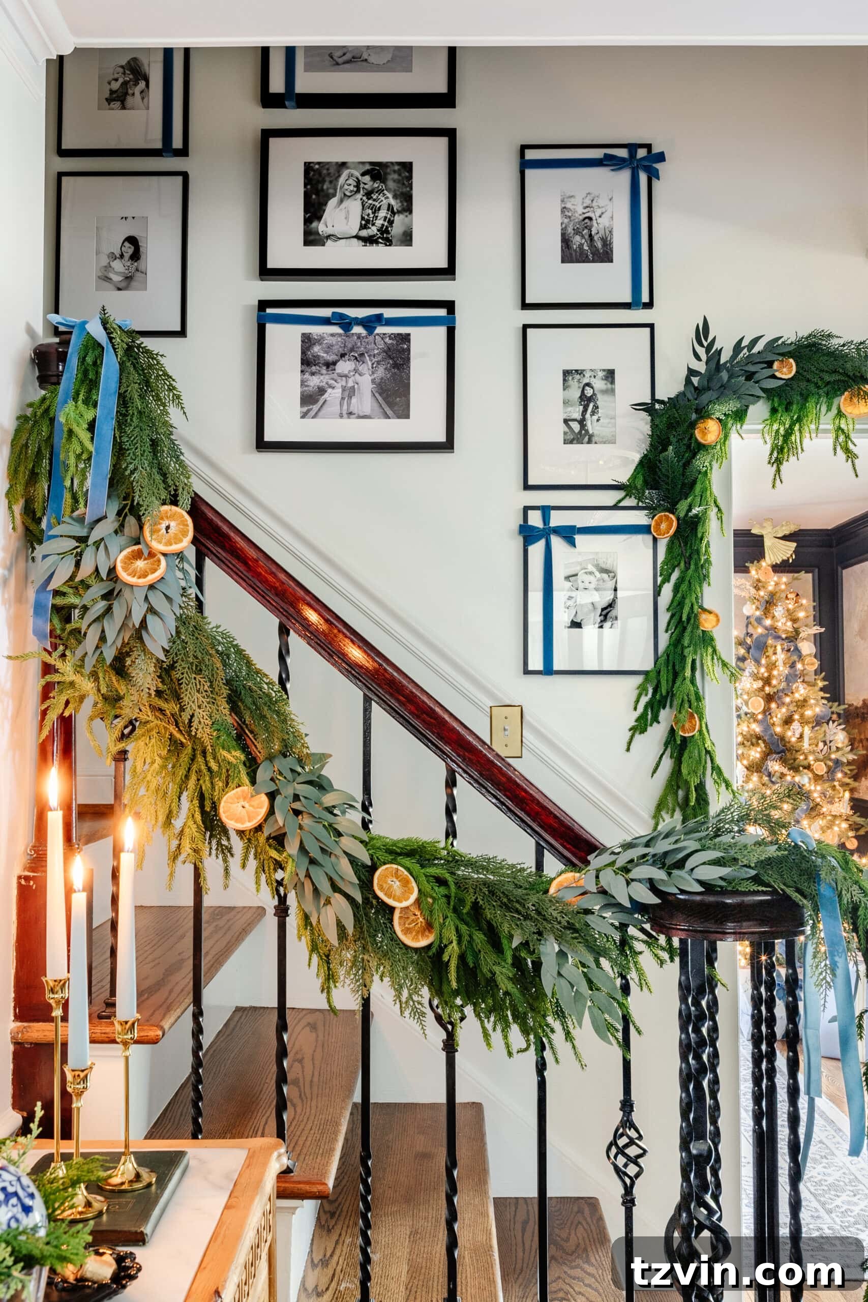 Effortless 5 Minute Holiday Ribbon Art 2 A charming family photo gallery wall adorned with festive Christmas bows, gracefully accentuating the staircase and creating a warm holiday ambiance.